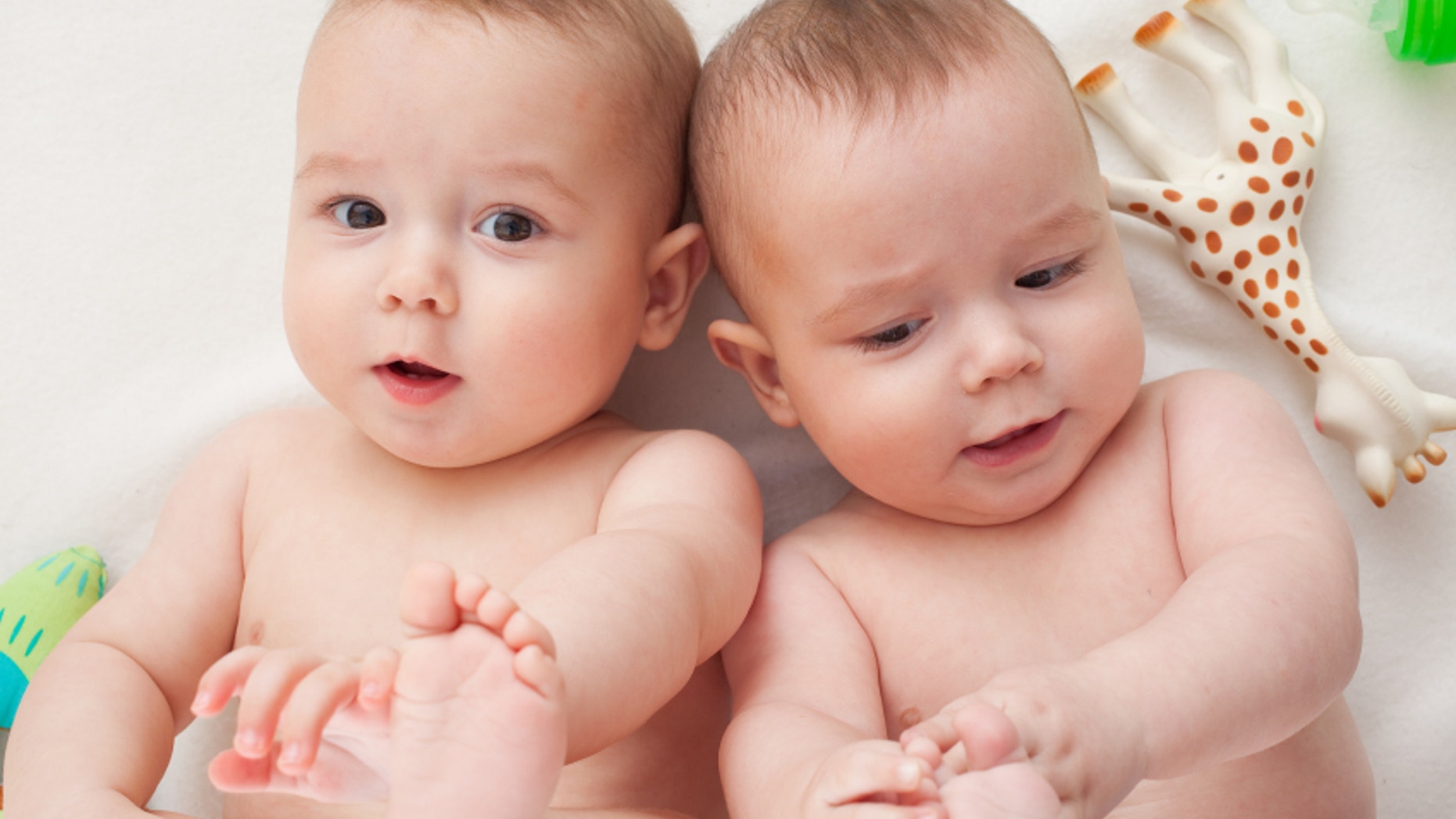 young twins are touching their little feet