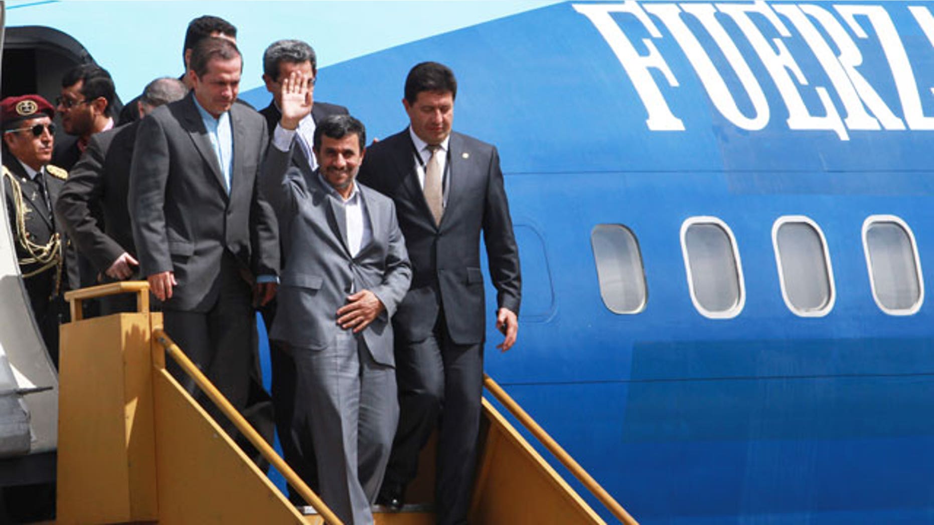 January, 12, 2012: Iran's President Mahmoud Ahmadinejad waves as he exits a plane upon arrival to an air force base in Quito, Ecuador.