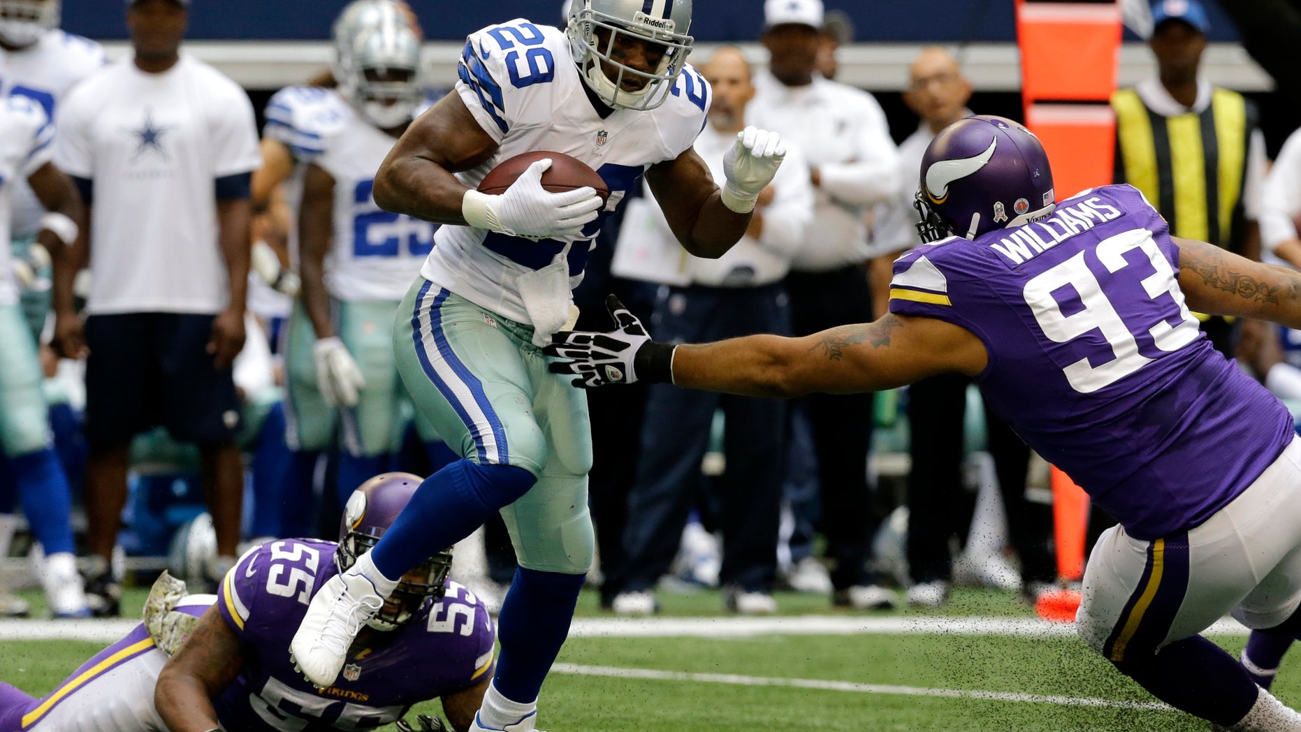 Dallas Cowboys running back DeMarco Murray (29) escapes tackle attempts by Minnesota Vikings' Marvin Mitchell (55) and Kevin Williams (93) for extra yardage in the first half of an NFL football game, Sunday, Nov. 3, 2013, in Arlington, Texas. (AP Photo/Nam Y. Huh)
