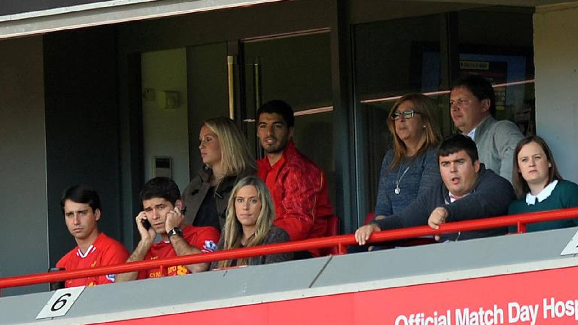 Liverpool's Luis Suarez watches from a hospitality box at Anfield stadium in Liverpool, on September 21, 2013.