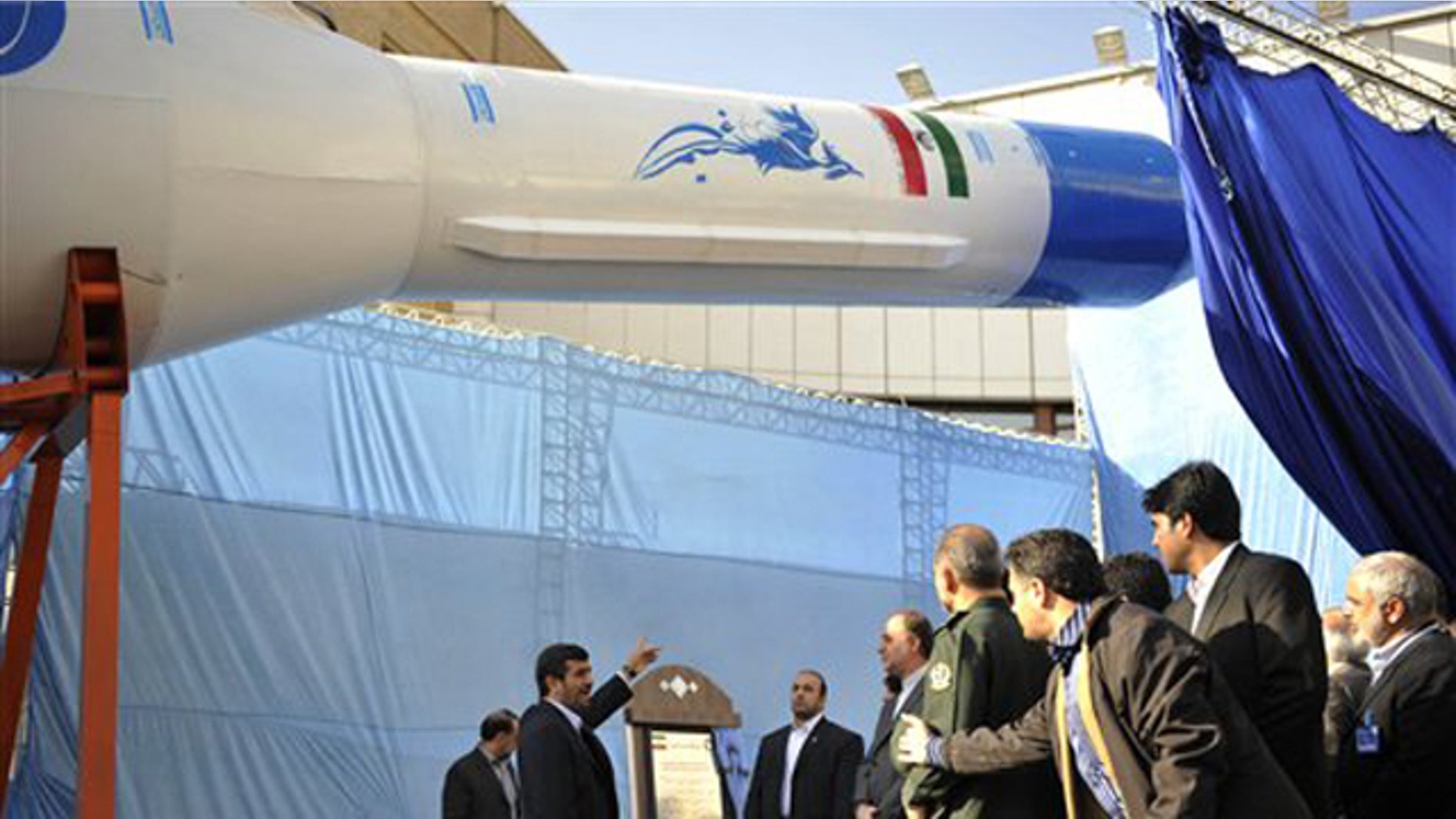 Feb. 3: Iranian President Mahmoud Ahmadinejad, center, gestures towards a model of Iran's domestically-built light booster rocket, named Simorgh -- part of an ambitious space program that has worried Western powers because they fear the same technology used to launch satellites could also deliver warheads.
