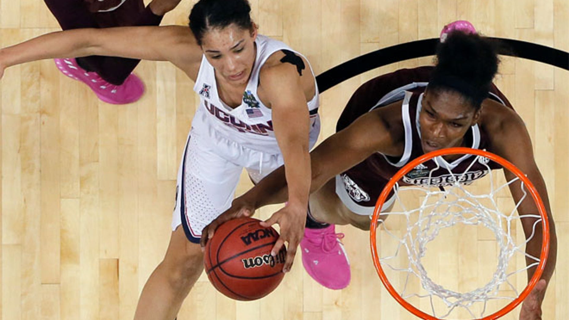 Connecticut guard Gabby Williams, left, is blocked by Mississippi State center Teaira McCowan
