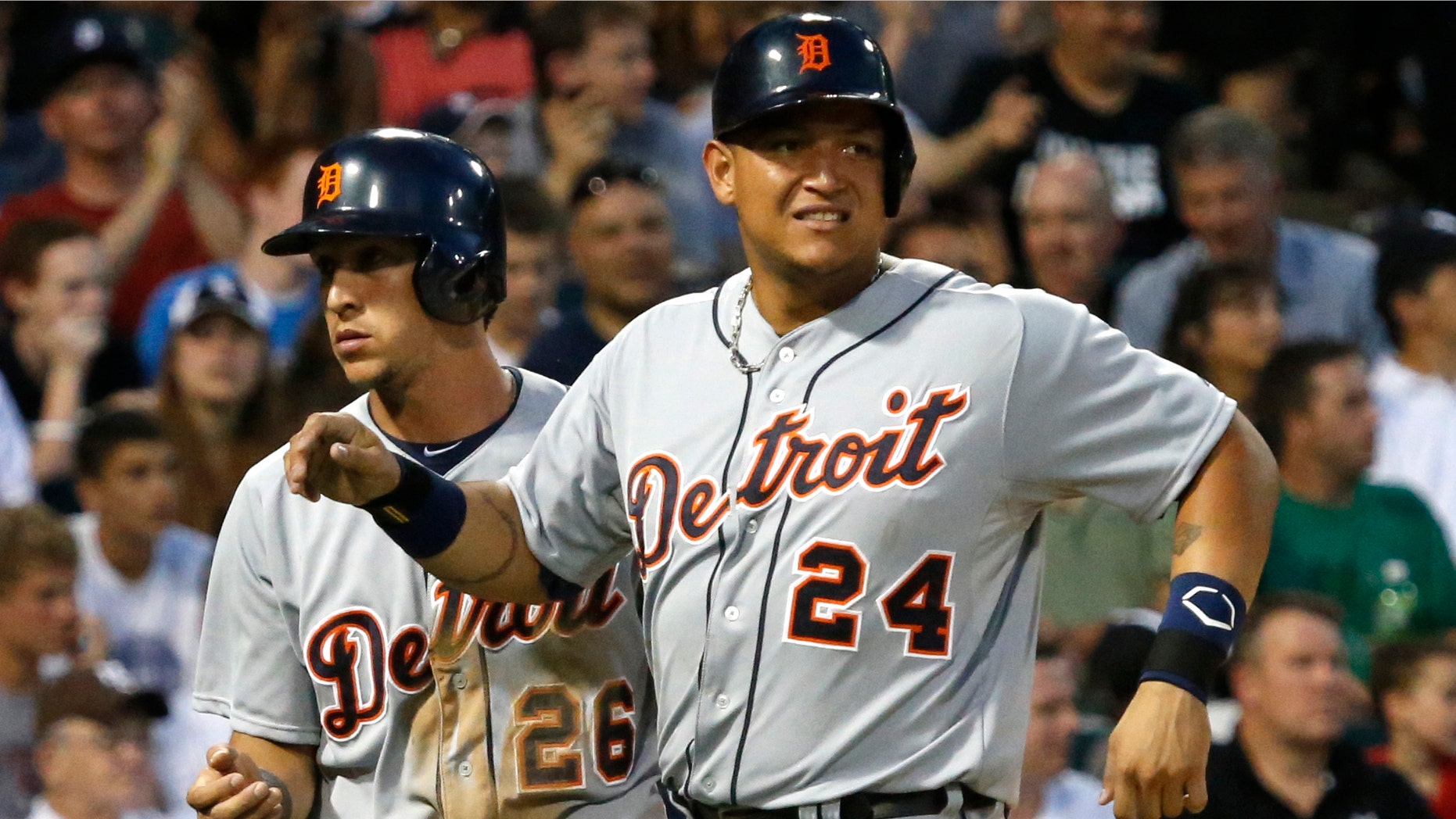 Detroit Tigers' Miguel Cabrera, right, grimaces after scoring with Hernan Perez, left, on a single by Victor Martinez, off a pitch by Chicago White Sox starting pitcher Chris Sale, during the fifth inning of a baseball game Monday, July 22, 2013, in Chicago. Cabrera left the game in the bottom of the fifth. (AP Photo/Charles Rex Arbogast)