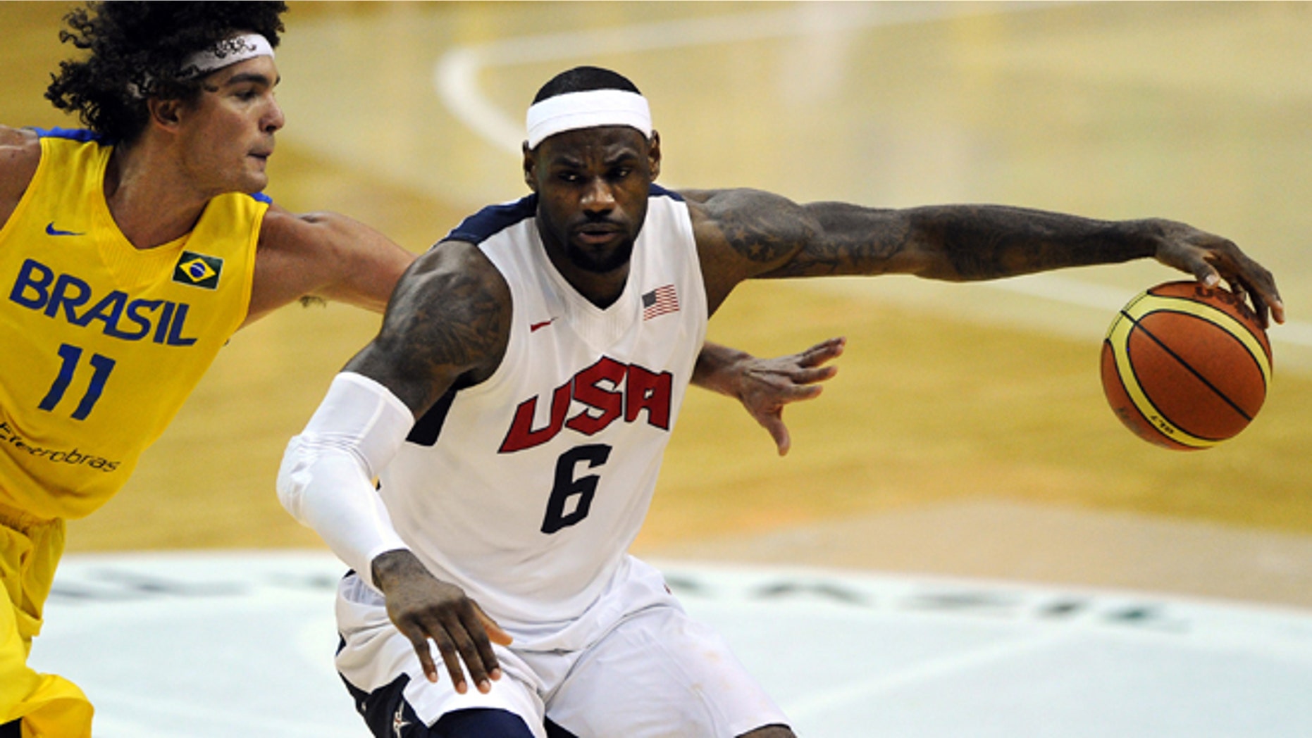 WASHINGTON, DC - JULY 16: LeBron James #6 of the US Men's Senior National Team dribbles past Anderson Franca Varejao #11 of Brazil in the third quarter during a pre-Olympic exhibition basketball game at the Verizon Center on July 16, 2012 in Washington, DC. The US Senior Men's National Team won, 80-69. (Photo by Patrick Smith/Getty Images)