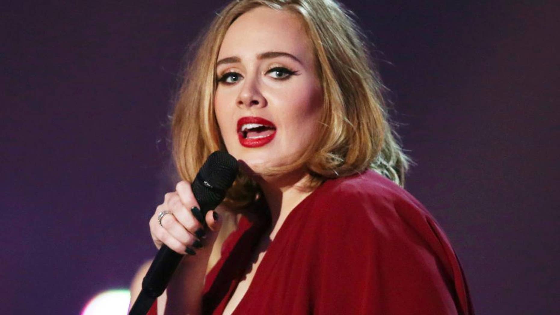 FILE - In this Feb. 24, 2016 file photo shows Adele onstage at the Brit Awards 2016 at the 02 Arena in London. NFL and Pepsi said Monday they have had several conversations with artists about performing at the Super Bowl, but said they haven’t formally asked Adele or any other musicians to appear. The British singer told an audience Saturday, Aug. 13, 2016, at her Los Angeles concert that she was asked to perform at the event. (Photo by Joel Ryan/Invision/AP, File)
