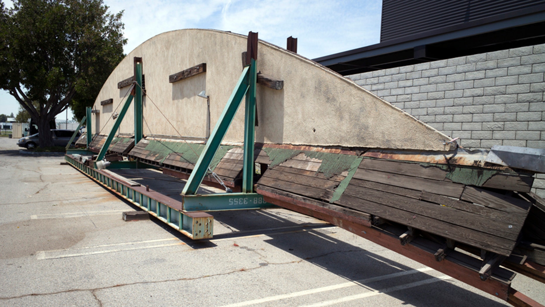 This May 23, 2017, photo shows part of the disassembled hangar facade that framed the opening scene of the 1942 film "Casablanca," where it is stored in a parking lot at Van Nuys Airport in Los Angeles' San Fernando Valley. Christine Dunn, who with her late husband recovered the hangar 10 years ago, told the Daily News on Sunday, May 28, that it'll be moved to Valley Relics Museum, home to many pop culture items.