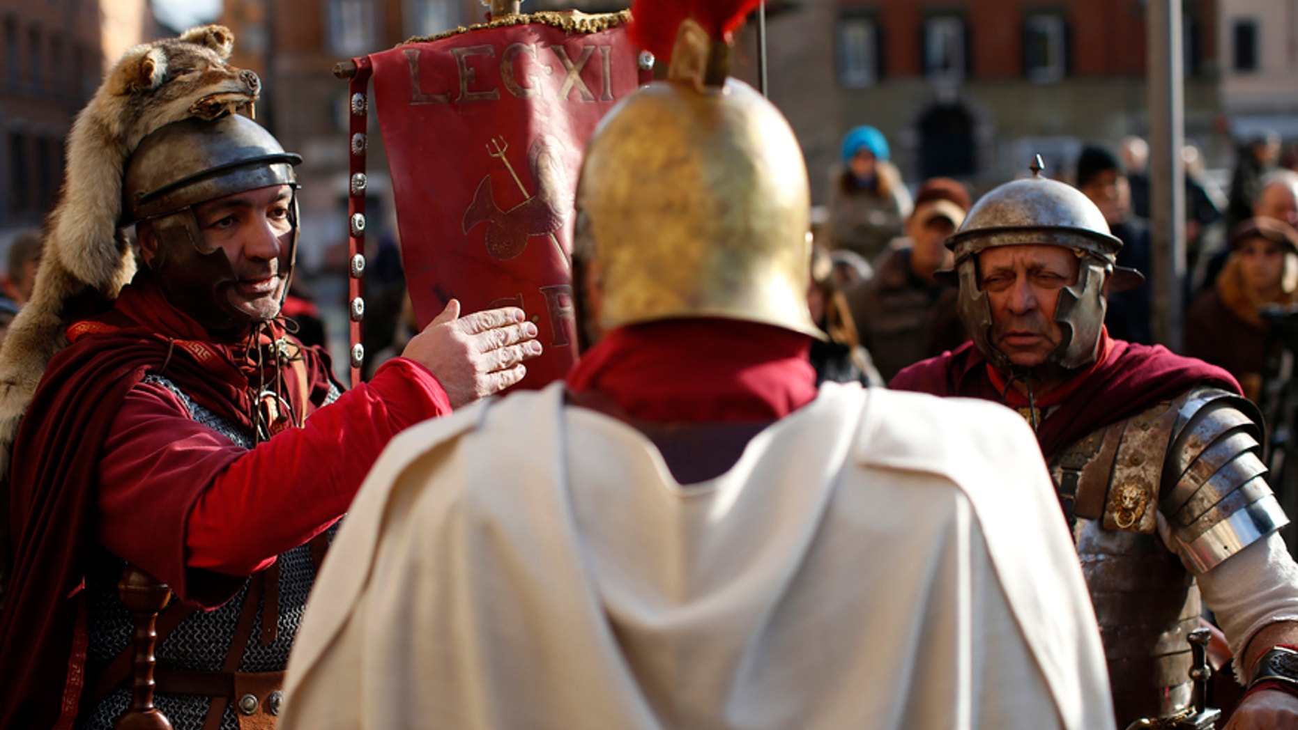 Members of Roman historical society "Gruppo Storico Romano" talk before taking part in a re-enactment of the "Ides of March", known also as the date on which Julius Caesar was assassinated in 44 BC, in downtown Rome.