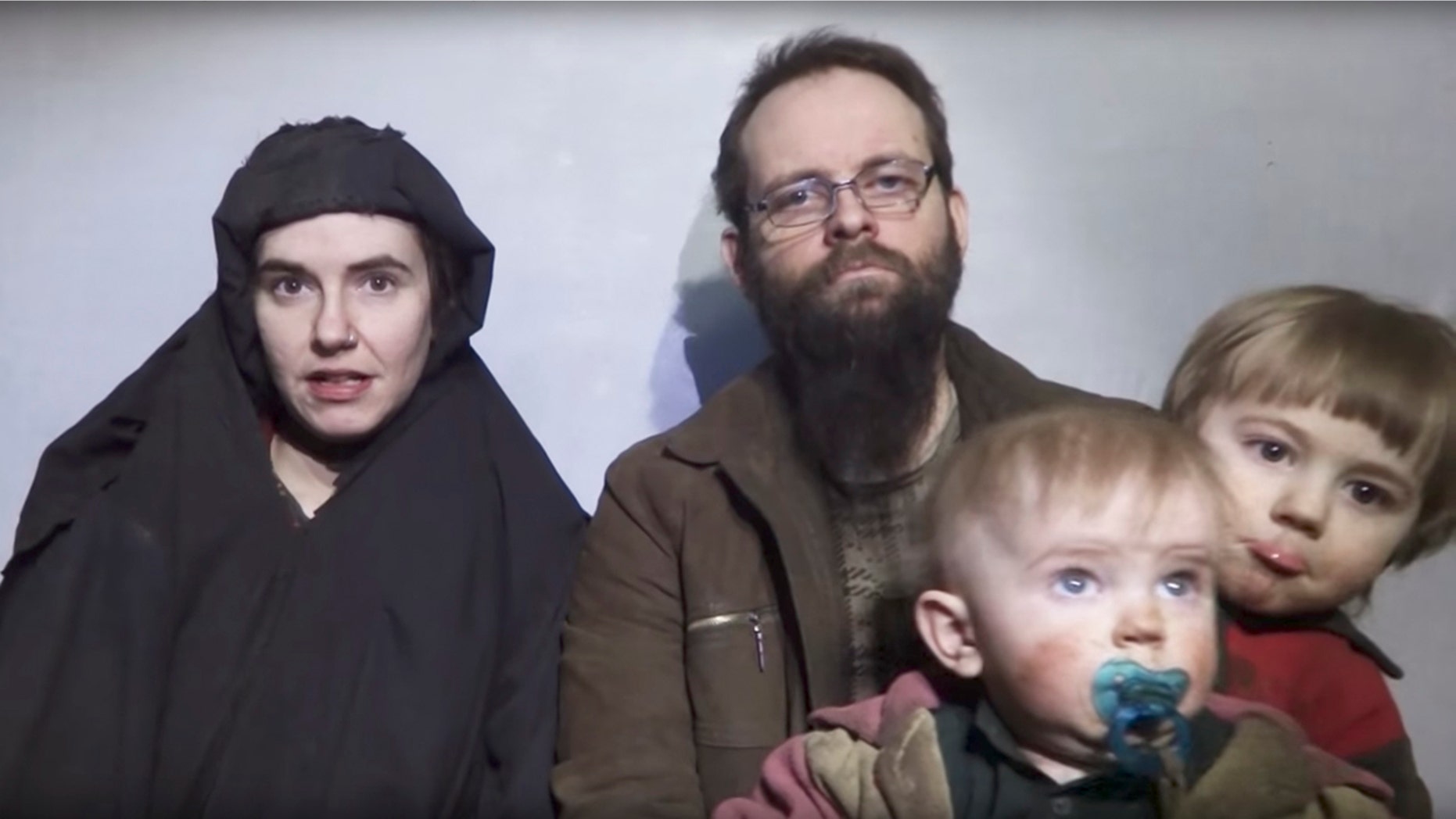 FILE - In this file image from video released by Taliban Media in December 2016, Caitlan Coleman talks in the video while her Canadian husband Joshua Boyle holds their two children. The couple and their three children were rescued Wednesday, Oct. 12, 2017, five years after the couple was abducted in Afghanistan on a backpacking trip. The children were born in captivity. (Taliban Media via AP)