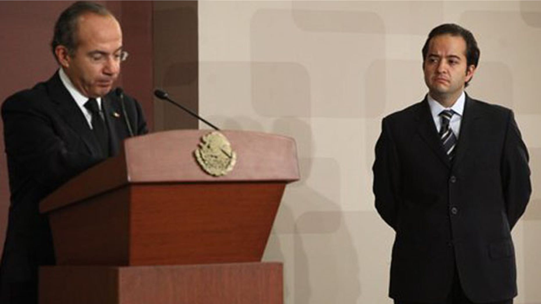 Mexico's new Interior Ministery Alejandro Poire, right, listens to Mexico's President Felipe Calderon during Poire's swearing-in ceremony in Mexico City, Thursday, Nov. 17, 2011. Poire, chief of Mexico's intelligence agency, replaces Francisco Blake Mora, who died in a Nov. 11 helicopter crash on the outskirts of Mexico City. (AP Photo/Alexandre Meneghini)