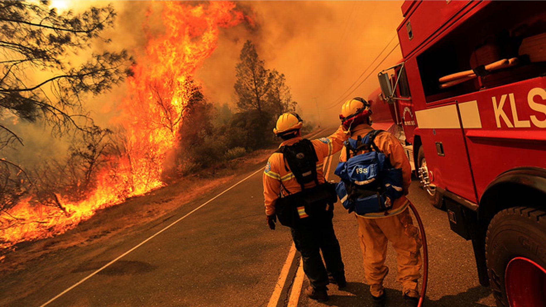 July 1, 2014: Kelseyville firefighters prepare to pull back from the fire on Butts Canyon Road as the fire jumps the road outside Middletown, California at the border between Lake and Napa counties.