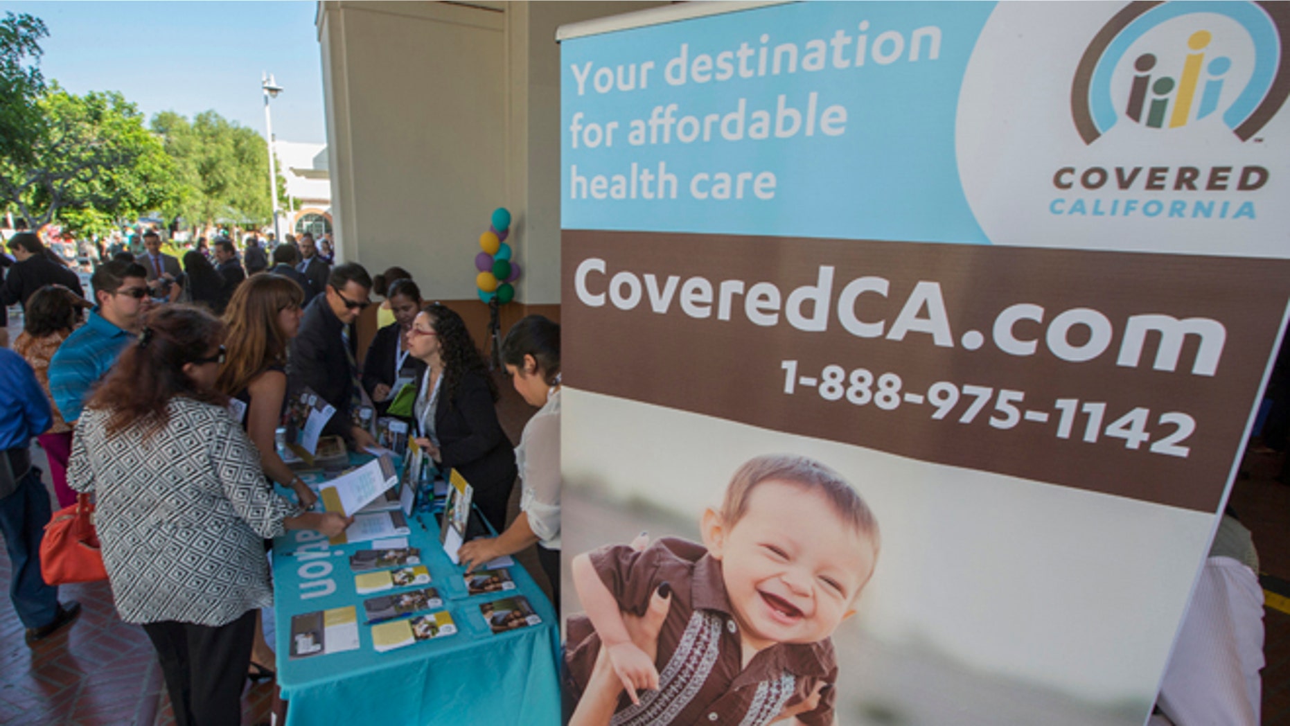 Oct. 1, 2013: People sign up for health insurance information at a Covered California event which marks the opening of the state's Affordable Healthcare Act, commonly known as Obamacare.