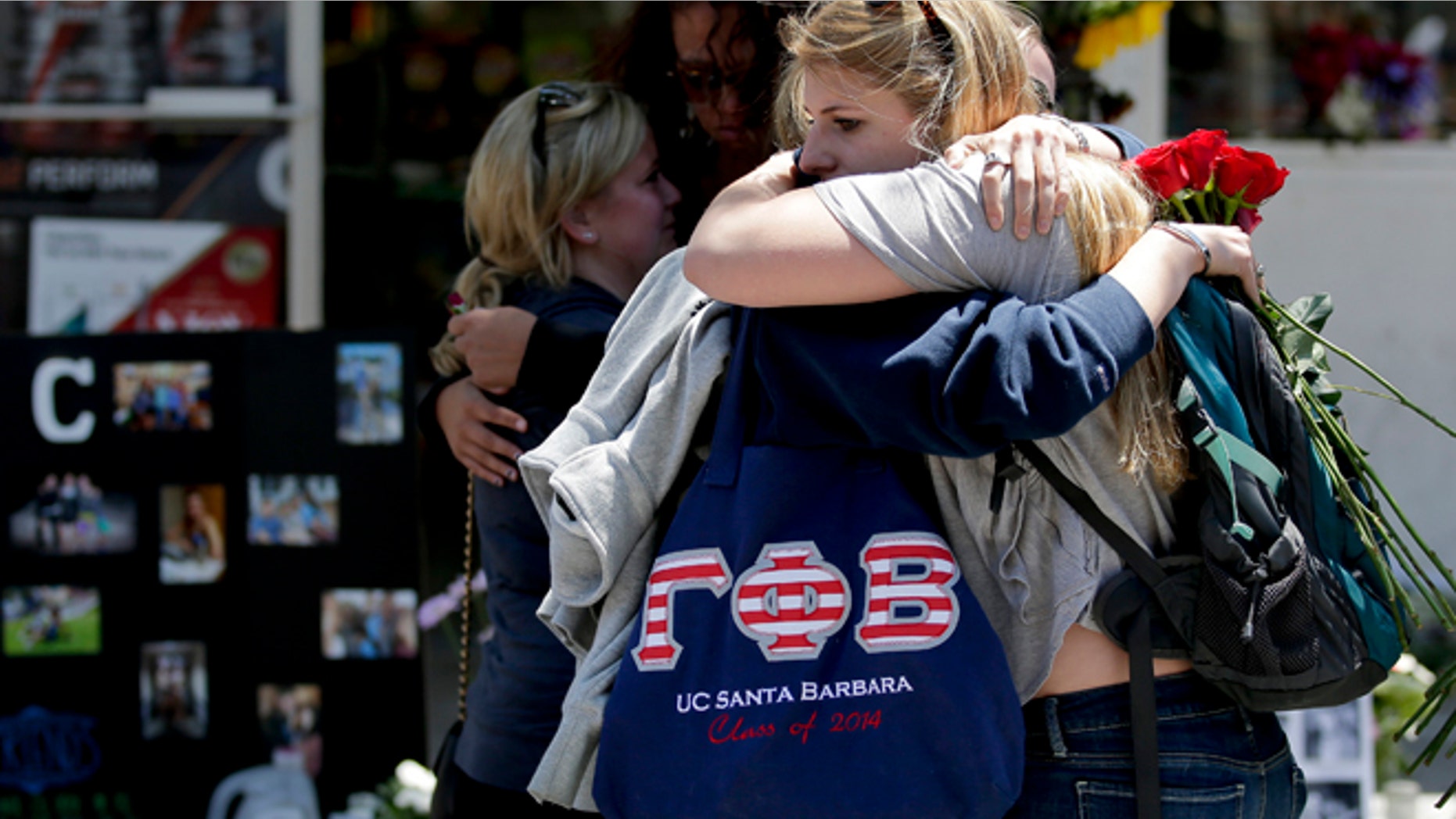 May 27, 2014: Mourners hug in front of the IV Deli Mart, where part of Friday night's mass shooting took place in the Isla Vista area near Goleta, Calif.