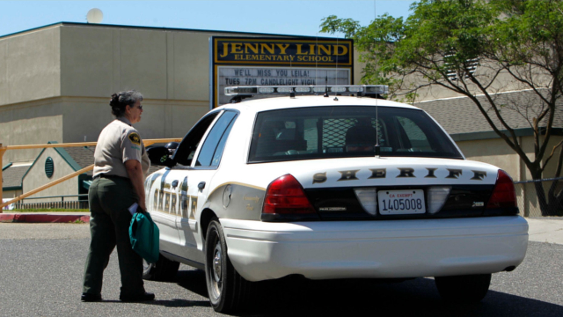 April 29, 2013: Calaveras County Sheriff's deputies and volunteers stand watch at Jenny Lind Elementary School, after the murder of one it's students over the weekend, in Valley Springs, Calif.