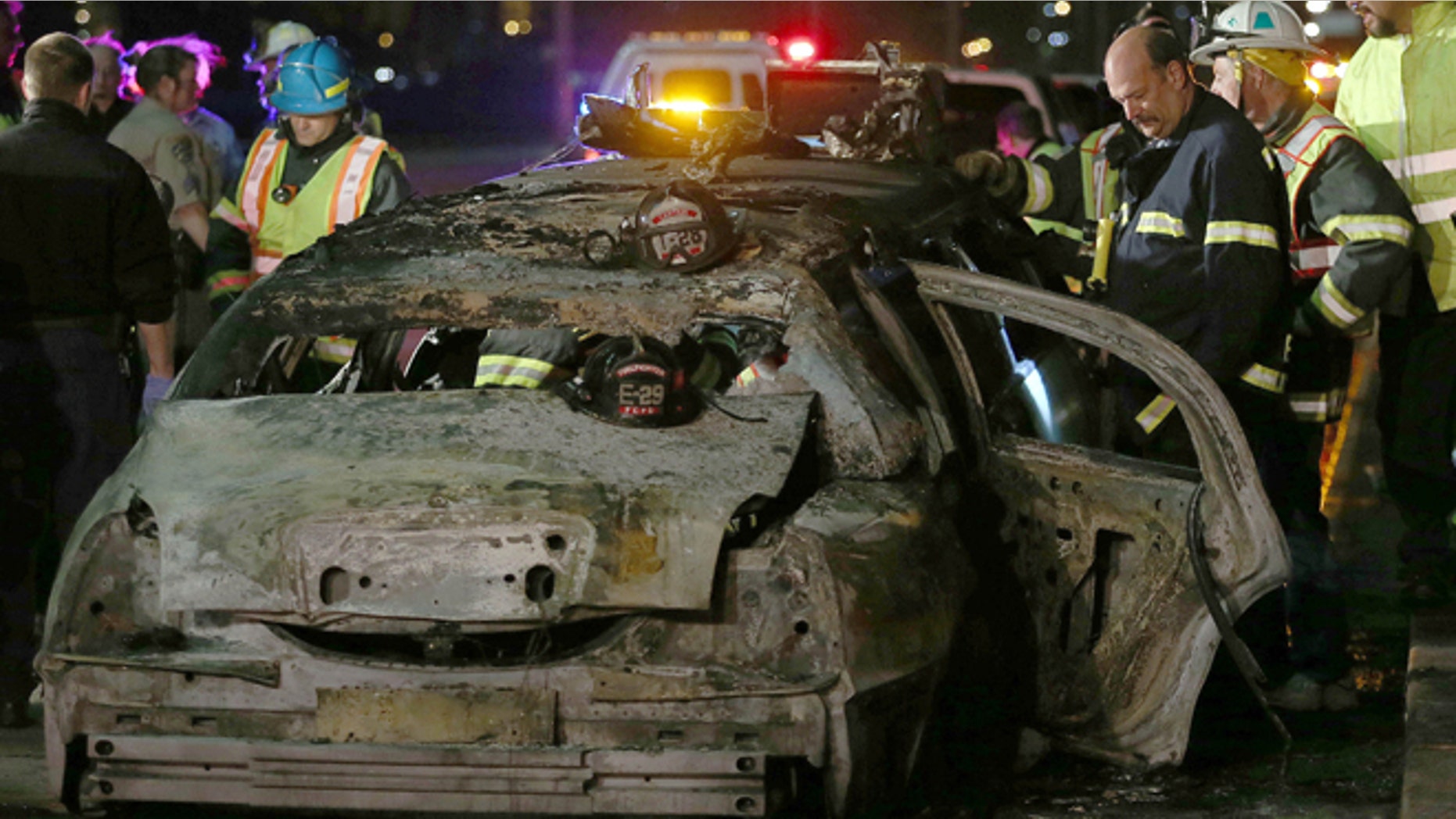 FILE: May 4, 2013: San Mateo County firefighters and California Highway Patrol personnel investigate the scene of a limousine fire on the westbound side of the San Mateo-Hayward Bridge in Foster City, Calif.