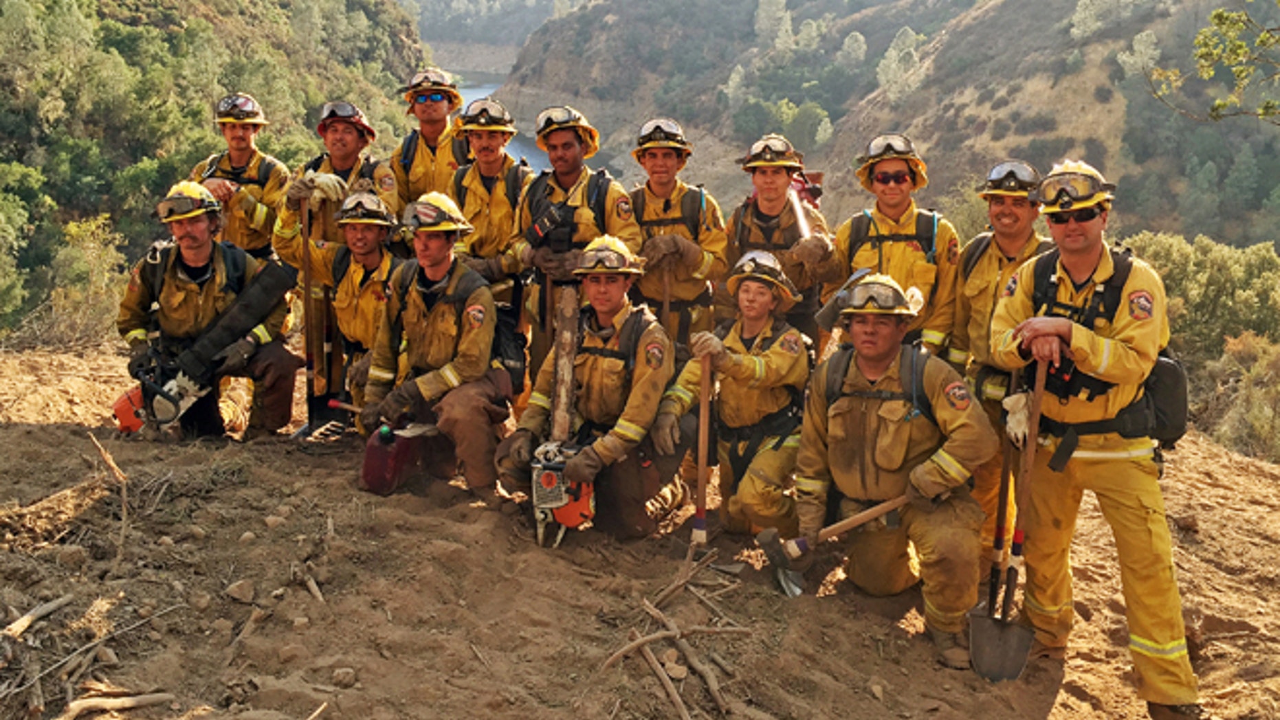 In this Aug. 15, 2016 photo provided by the California Conservation Corps, a civilian firefighter crew poses for a group photo during their deployment on the Chimney Fire in San Luis Obispo County, Calif.
