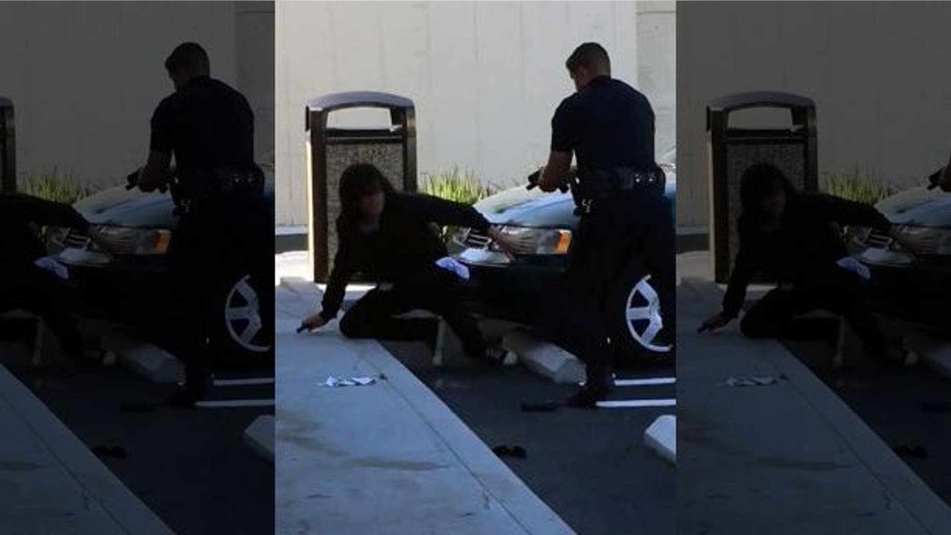 This image from a video posted on Twitter shows a confrontation between a police officer and an unidentified man outside a convenience store in Huntington Beach, Calif.