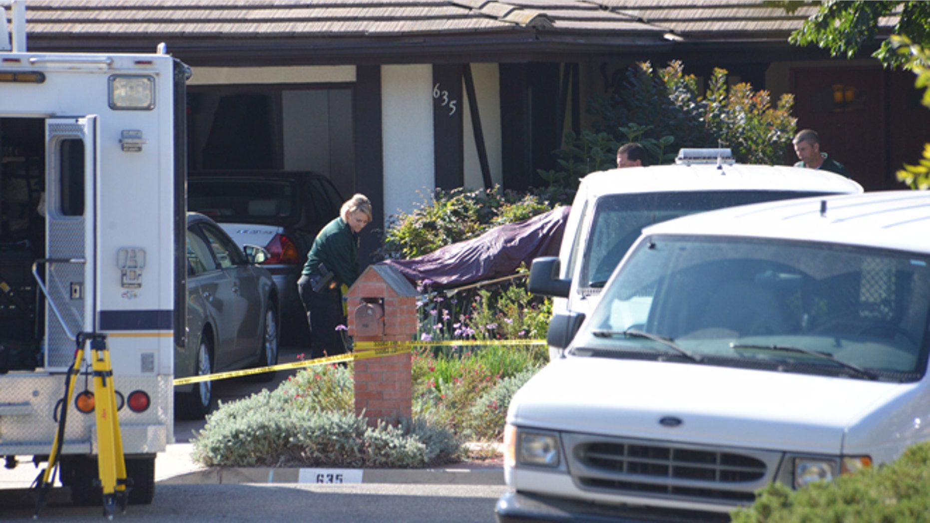 Aug. 12, 2014: Investigators remove a body from a home in Goleta, Calif., where four people and a dog were found stabbed to death the night before.