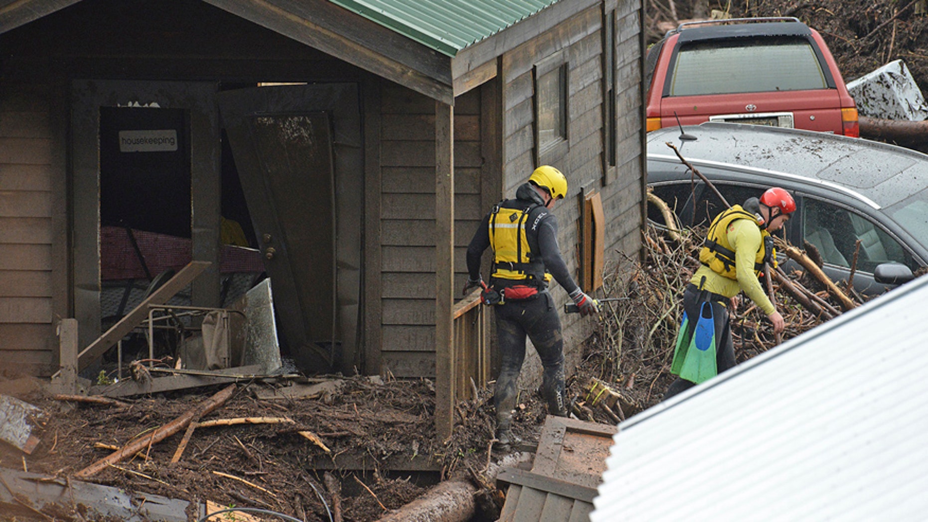 Rescue crews search for victims Friday, Jan. 20, 2017 at the El Capitan Canyon campground following flooding due to heavy rains in Gaviota, Calif. Dozens of campers were rescued and evacuated following the morning flood that swept large wooden cabins and vehicles away. (Mike Eliason/Santa Barbara County Fire Department via AP)