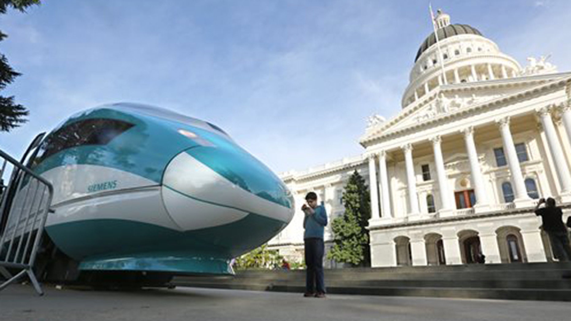 FILE - In this Feb. 26, 2015 file photo, a full-scale mock-up of a high-speed train is displayed at the Capitol in Sacramento, Calif. State officials will return to Sacramento Superior Court, Thursday, Feb. 11, 2016, to defend the project against critics who say high-speed rail cannot meet promises made to voters who approved a $9.9 billion bond measure to build it. (AP Photo/Rich Pedroncelli, File)