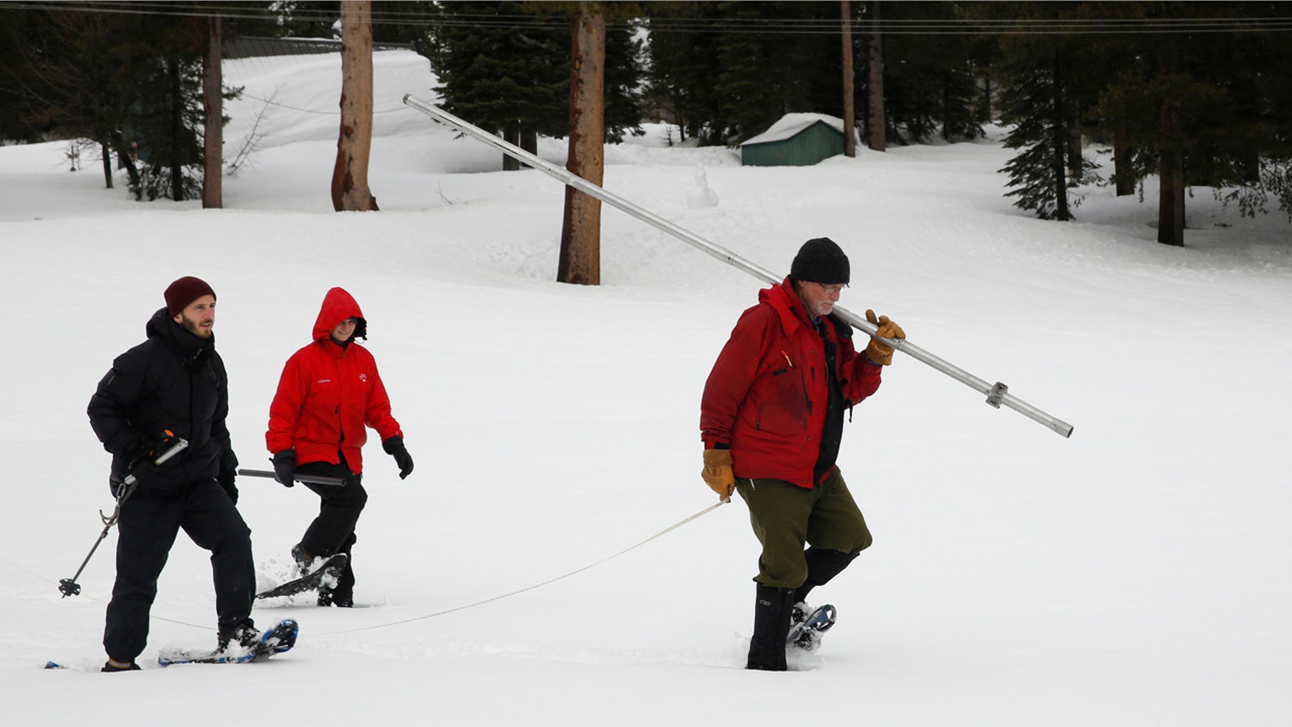 Feb. 2, 2017: Frank Gehrke, right, chief of the California Cooperative Snow Surveys Program for the Department of Water Resources, carries the snowpack measuring tube as he crosses a snow covered meadow while conducting the second manual snow survey of the season in Echo Summit, Calif.