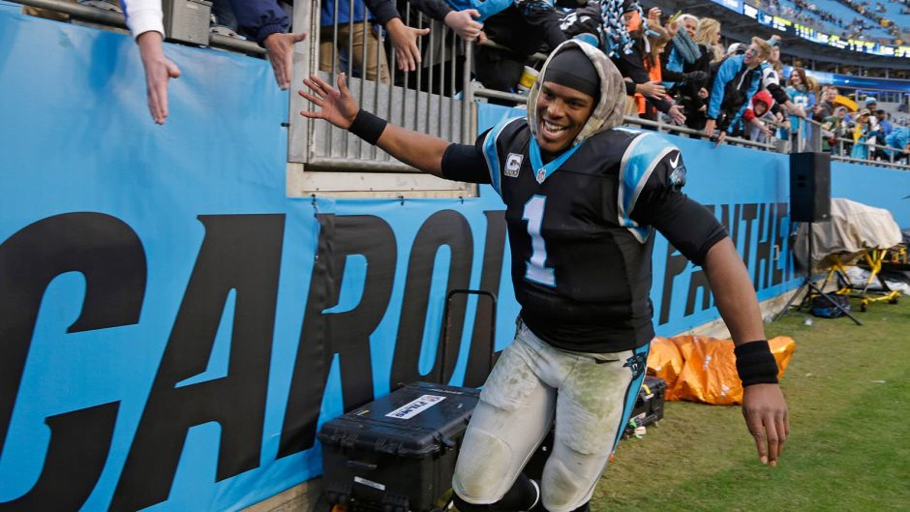 Carolina Panthers' Cam Newton (1) celebrates with fans after an NFL football game against the Green Bay Packers in Charlotte, N.C., Sunday, Nov. 8, 2015. The Panthers won 37-29. (AP Photo/Bob Leverone)