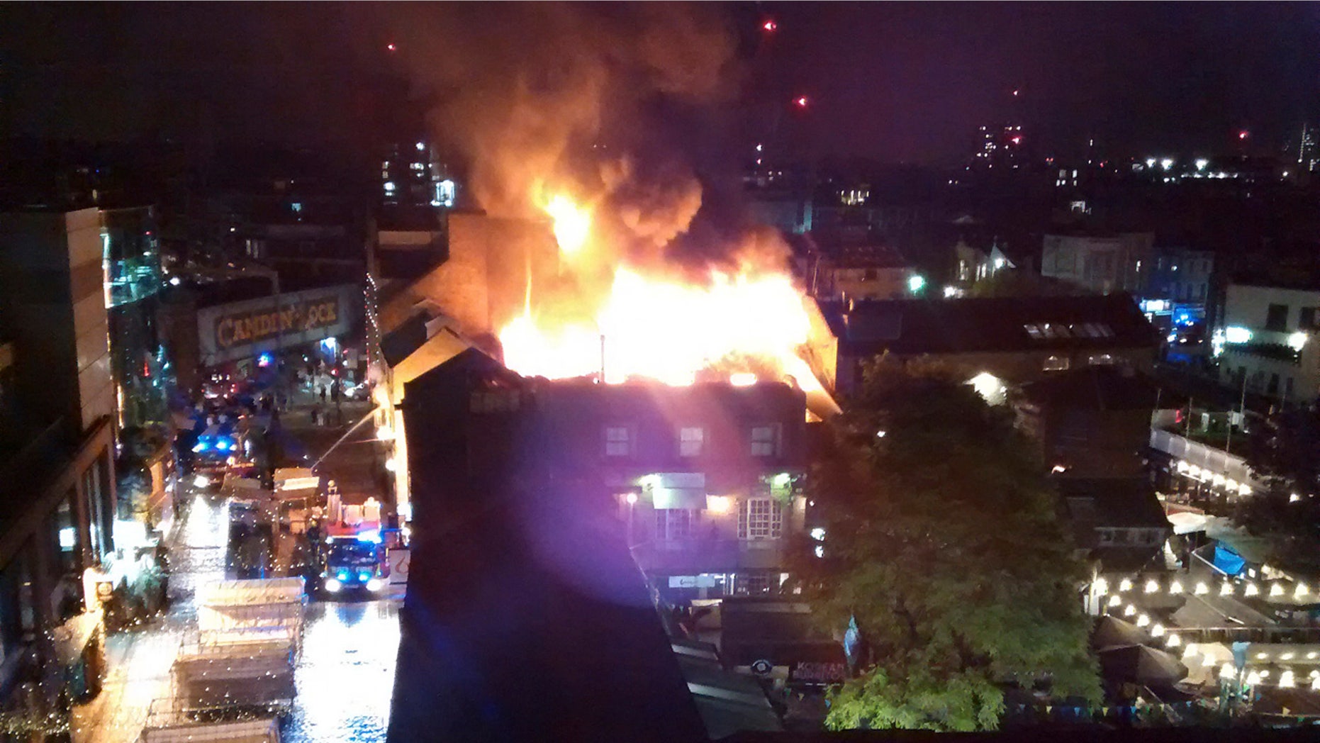 Flames and smoke rise from a fire affecting a small area of Camden Market in London early Monday.