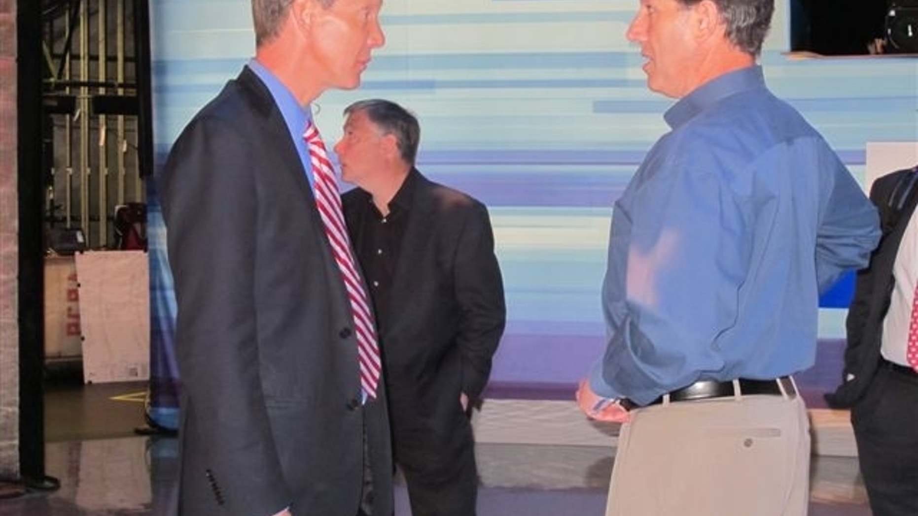 Fox News Chief Political Correspondent Carl Cameron talks with former Sen. Rick Santorum, R-Pa., on the stage of Thursday’s GOP debate in Greenville, S.C. (Fox News Photo / Katy Ricalde)