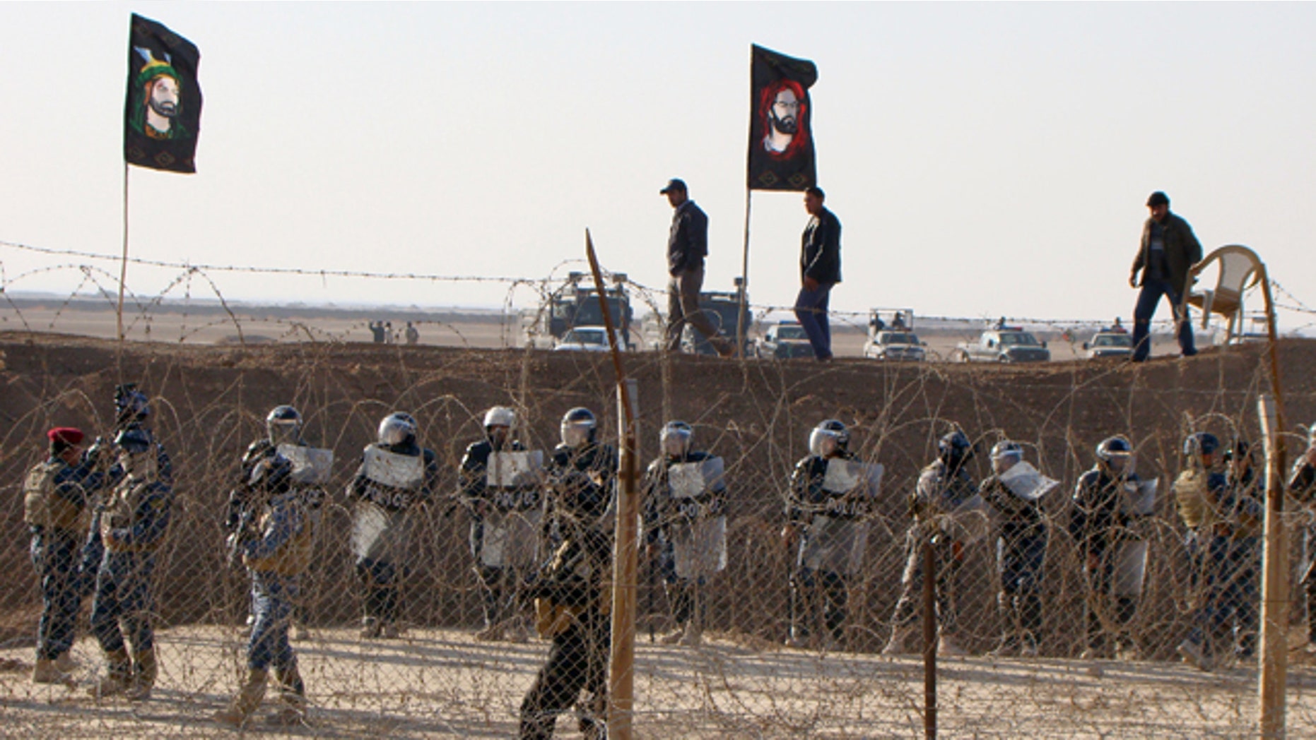 Dec. 9, 2011: In this photo provided by the People's Mujahedeen Organization of Iran, Iraqi police stand guard outside the opposition group's camp northeast of Baghdad, Iraq.