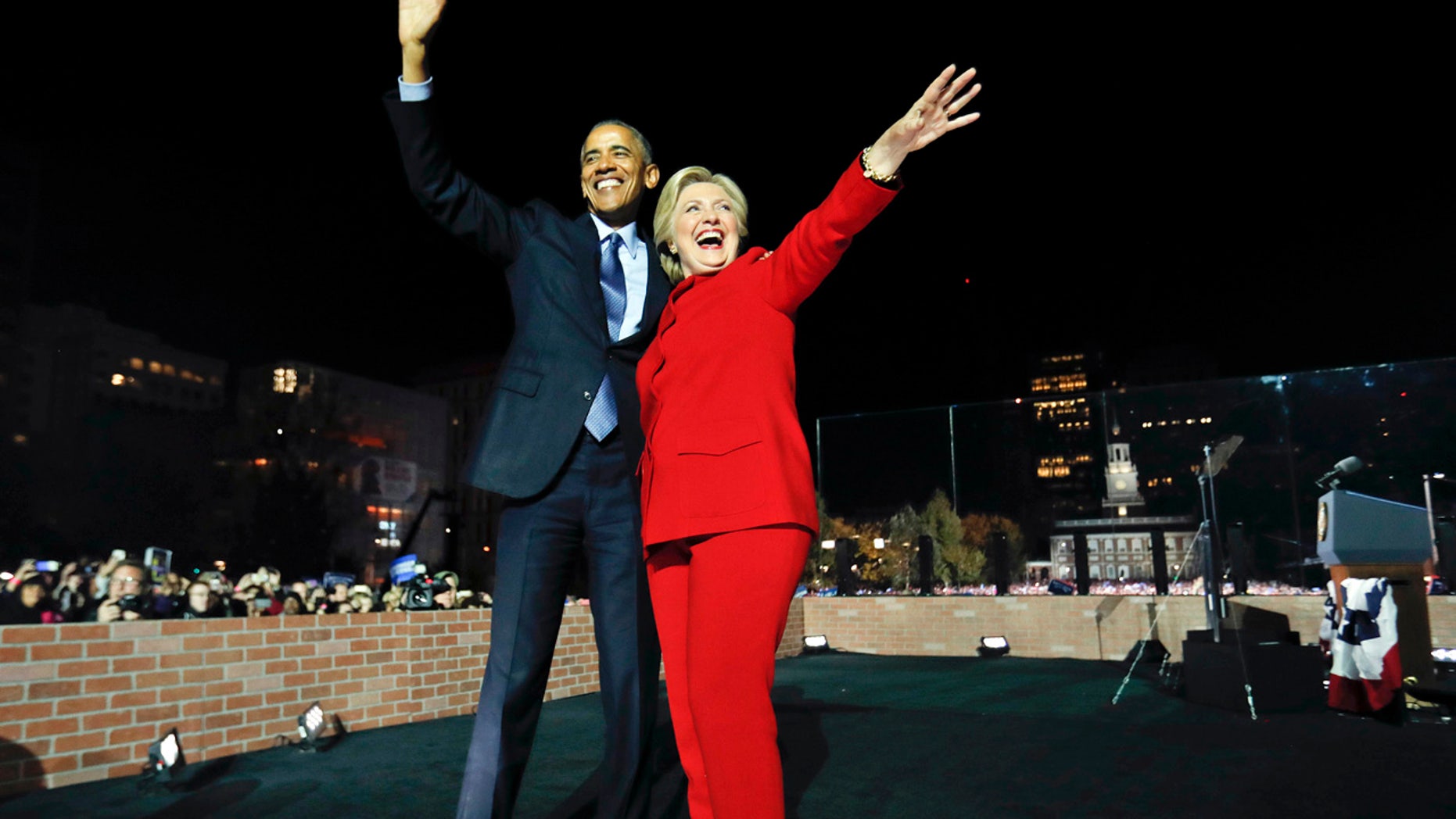President Barack Obama waves on stage with Democratic presidential candidate Hillary Clinton during a rally at Independence Hall in Philadelphia, Monday, Nov. 7, 2016.