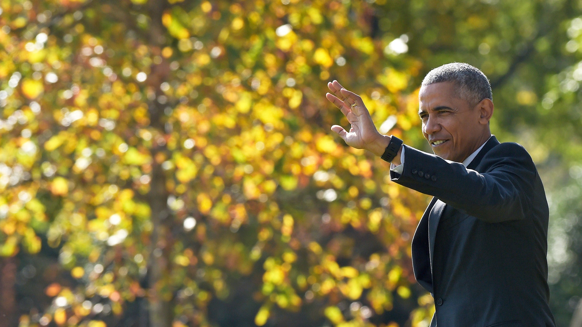 President Barack Obama waves as he walks towards Marine One.