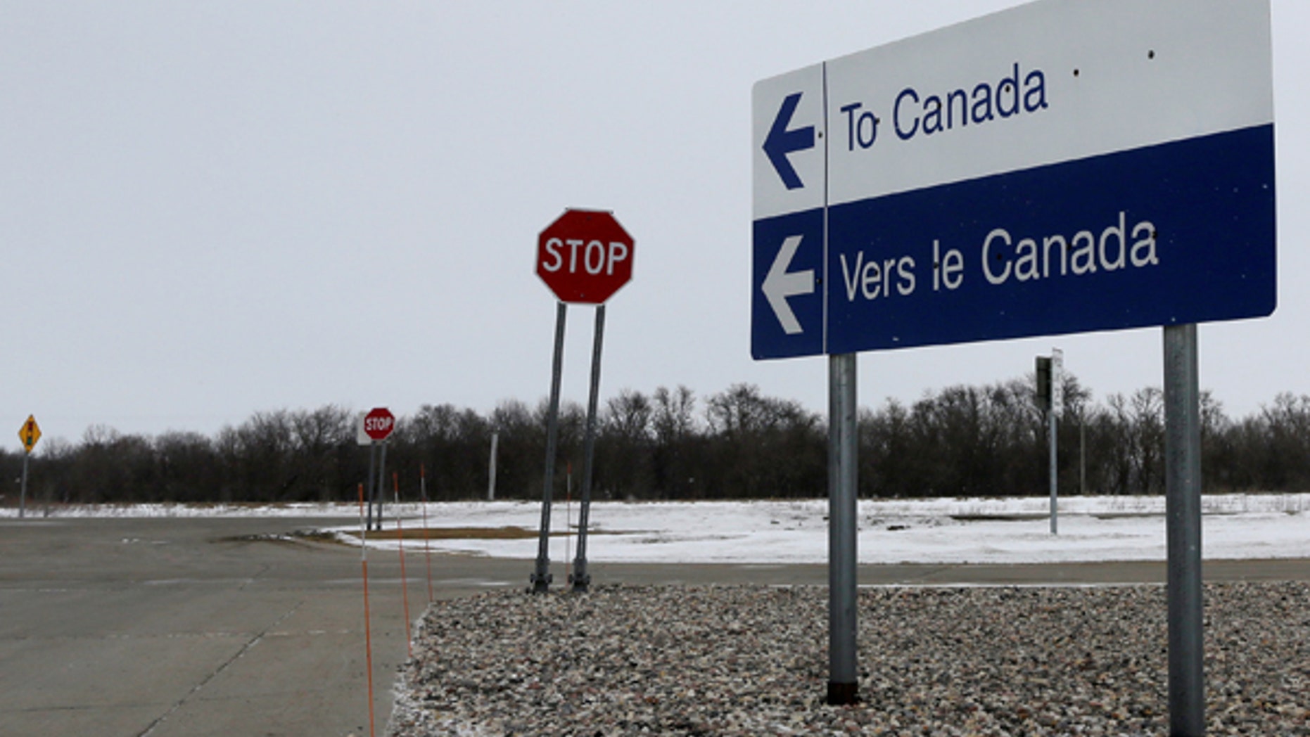 A highway traffic sign on the U.S side of the border pointing to the direction of Canada, at Emerson, Manitoba, Canada February 25, 2017. Picture taken February 25, 2017. REUTERS/Lyle Stafford - RTS10RK7
