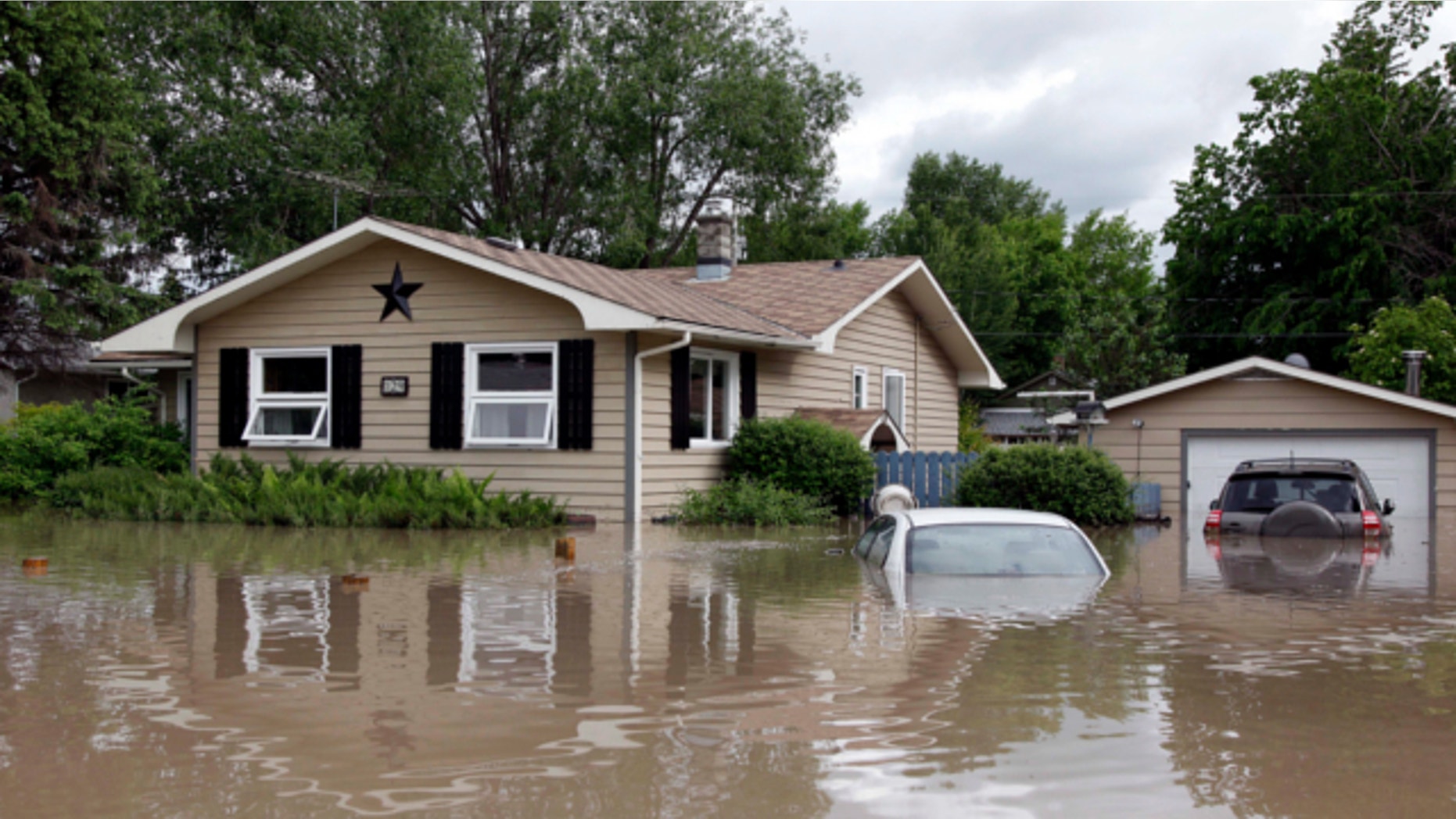 June 20, 2013: Cars and homes are submerged in flood waters in High River.
