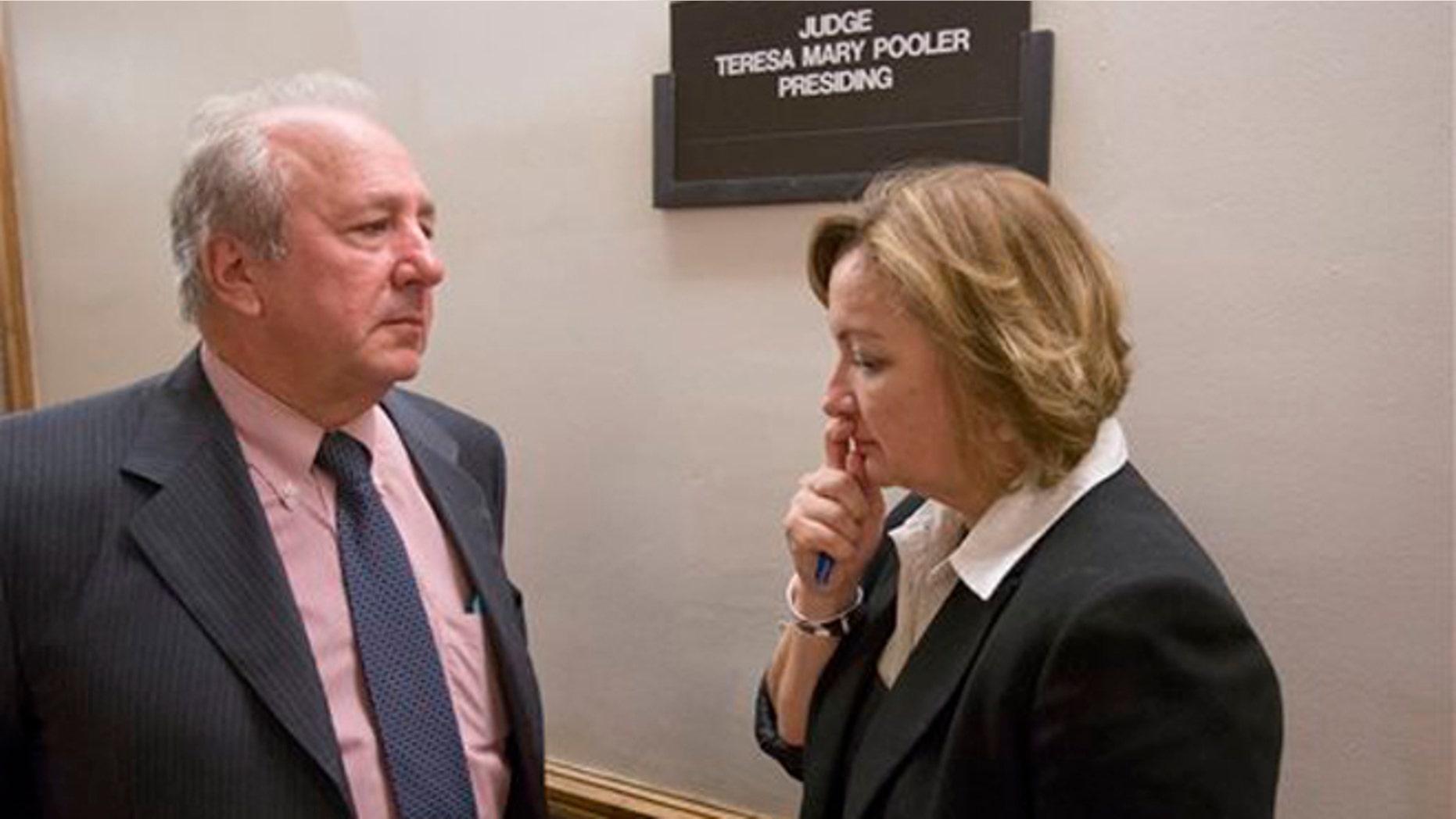 Canadian diplomat Roxanne Dube, right, speaks with attorney Curt Obront outside a courtroom at the Richard E. Gerstein Justice Building, Thursday, Feb. 4, 2016, in Miami. Dube's son, Marc Wabafiyebazu, 15, is charged with murder and other crimes in the March 30, 2015, drug-related South Florida shootout that killed his older brother and another youth. (AP Photo/Wilfredo Lee)