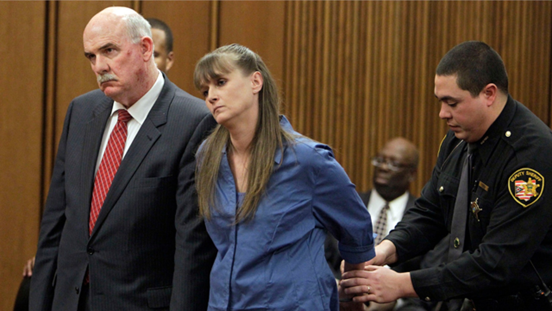 Feb. 16: Monica Hussing, center is handcuffed after being sentenced to eight years in prison on involuntary manslaughter charges in Cleveland.