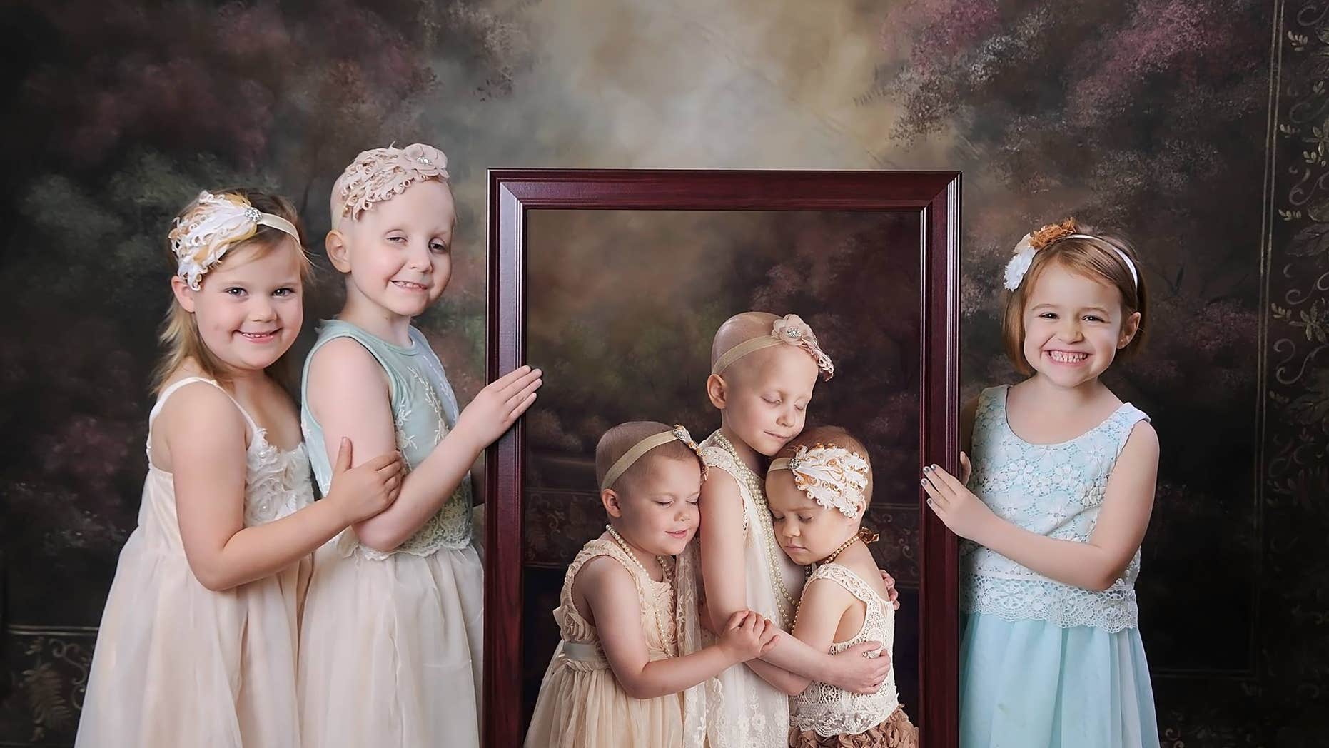 Rheanna, Ainsley and Rylie pose with the original photo of them taken two years ago.