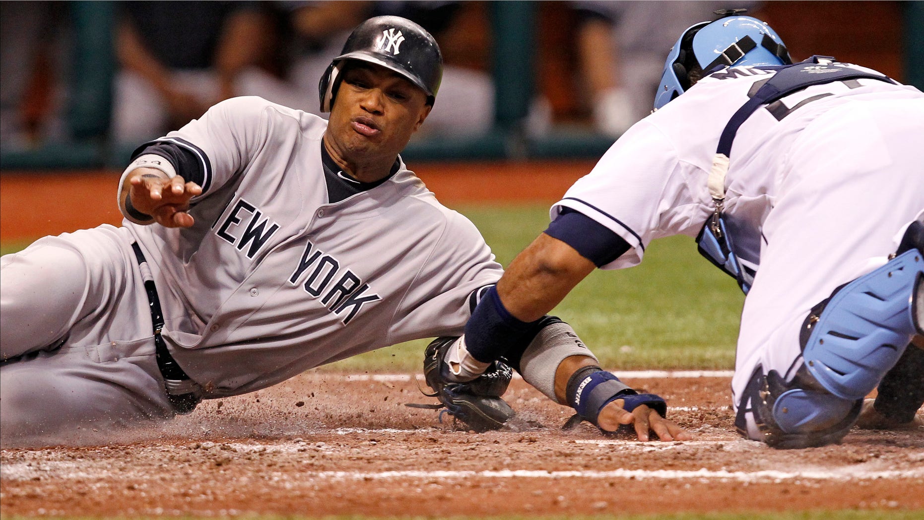 New York Yankees' Robinson Cano, left, is tagged out by Tampa Bay Rays catcher Jose Molina during the sixth inning of a baseball game Tuesday, July 3, 2012, in St. Petersburg, Fla. (AP Photo/Mike Carlson)