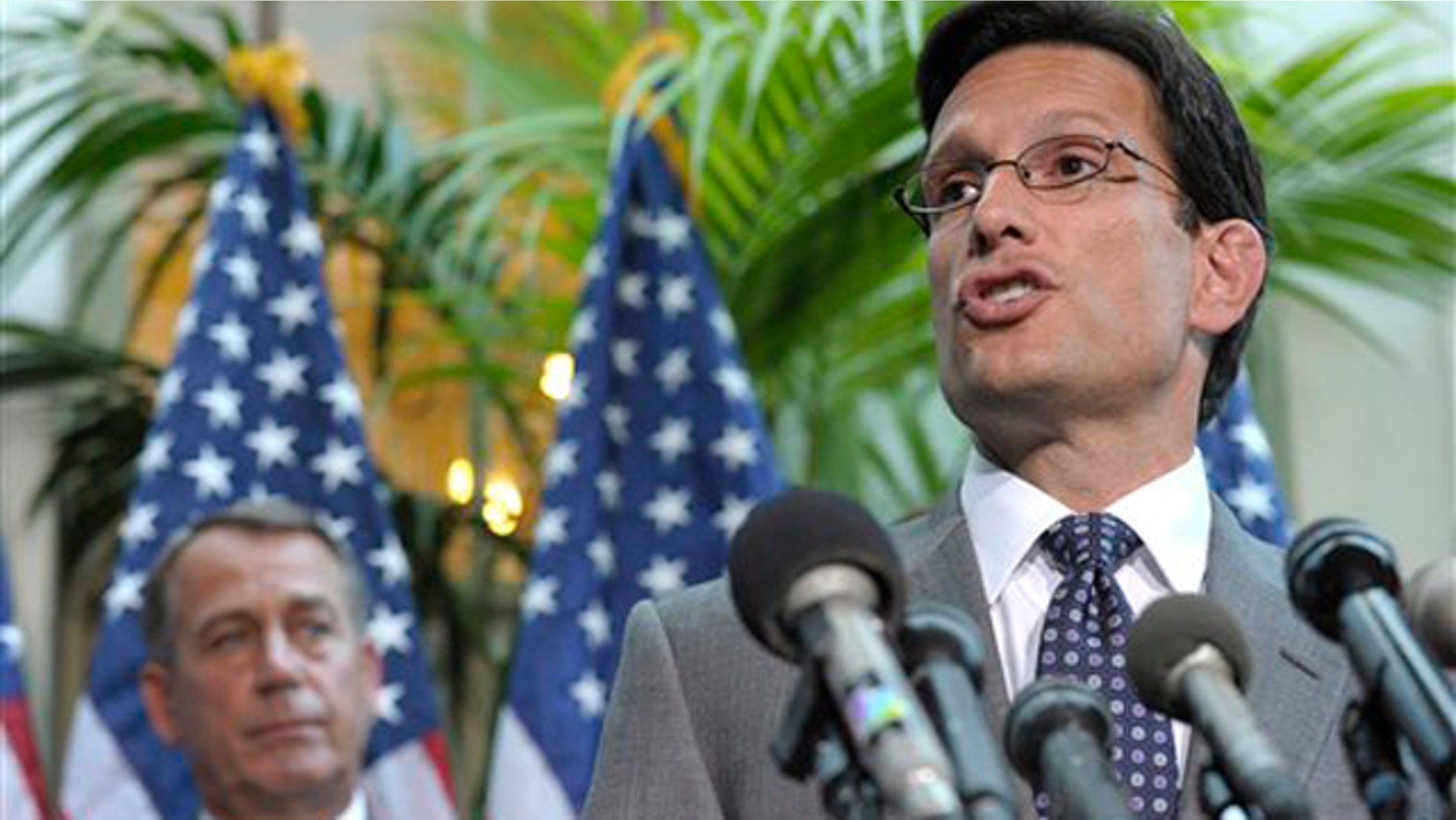 House Majority Leader Eric Cantor, right, accompanied by House Speaker John Boehner, speaks during a news conference on Capitol Hill July 12.