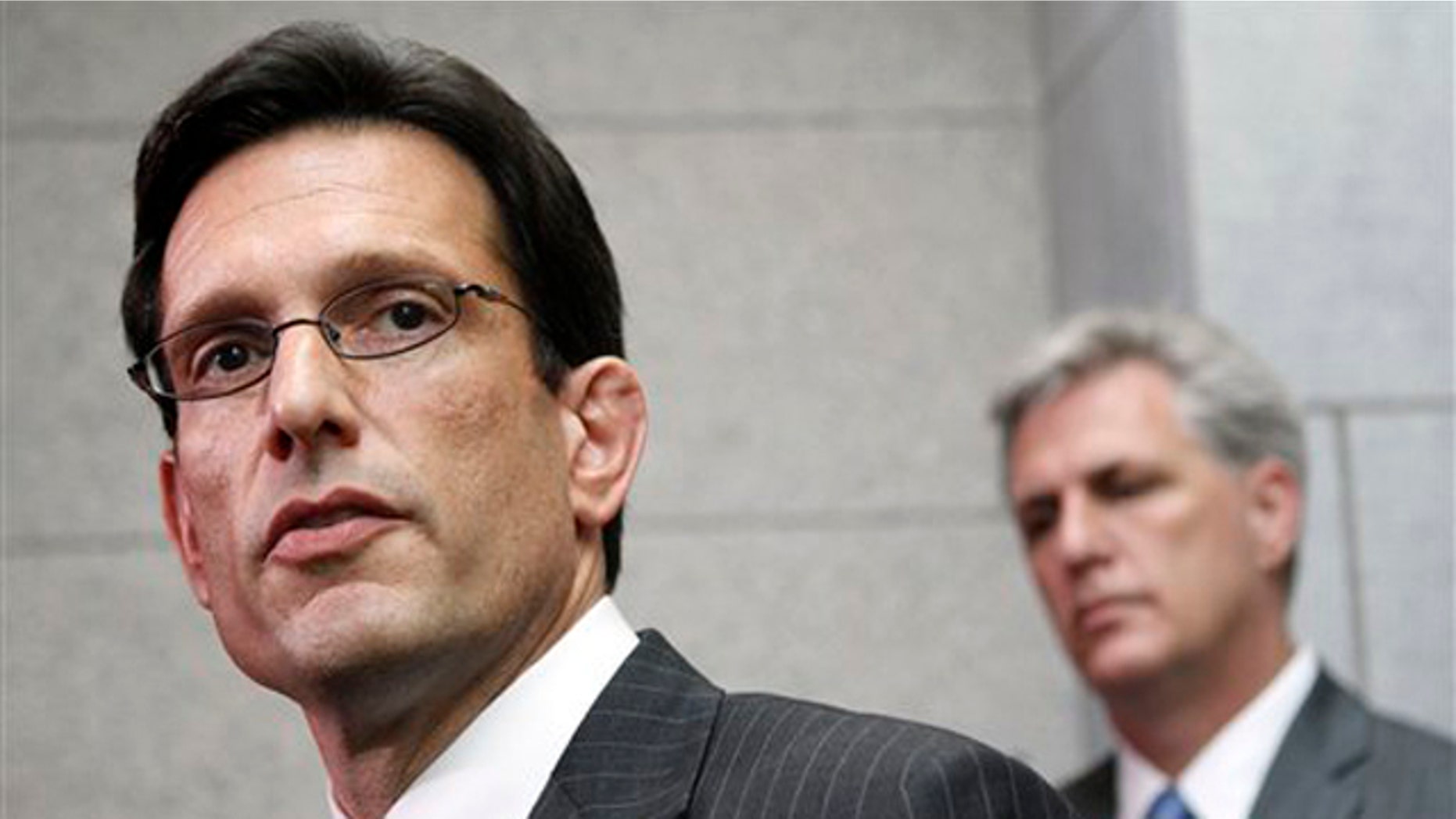 House Majority Leader Eric Cantor, left, accompanied by House Majority Whip Kevin McCarthy, speaks to reporters on Capitol Hill May 3.