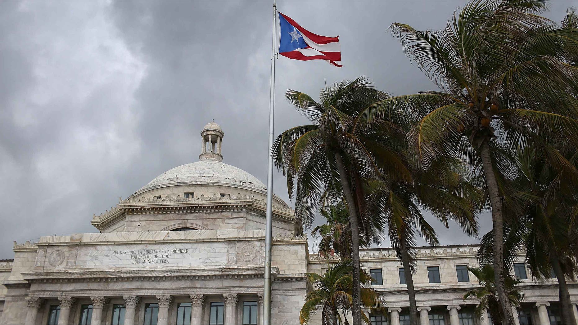 SAN JUAN, PUERTO RICO - JUNE 30: The Puerto Rican flag flies above the Capitol a day after Puerto Rican Governor Alejandro Garcia Padilla gave a televised speech regarding the governments $72 billion debt on June 30, 2015 in San Juan, Puerto Rico. The Governor said in his speech that the people will have to sacrifice and share in the responsibilities for pulling the island out of debt. (Photo by Joe Raedle/Getty Images)