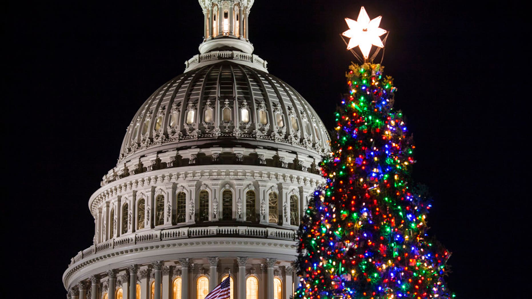 The Capitol Christmas tree is illuminated as lawmakers in the Senate work late into the evening on the Republican tax bill, in Washington, Tuesday, Dec. 19, 2017. (AP Photo/J. Scott Applewhite)
