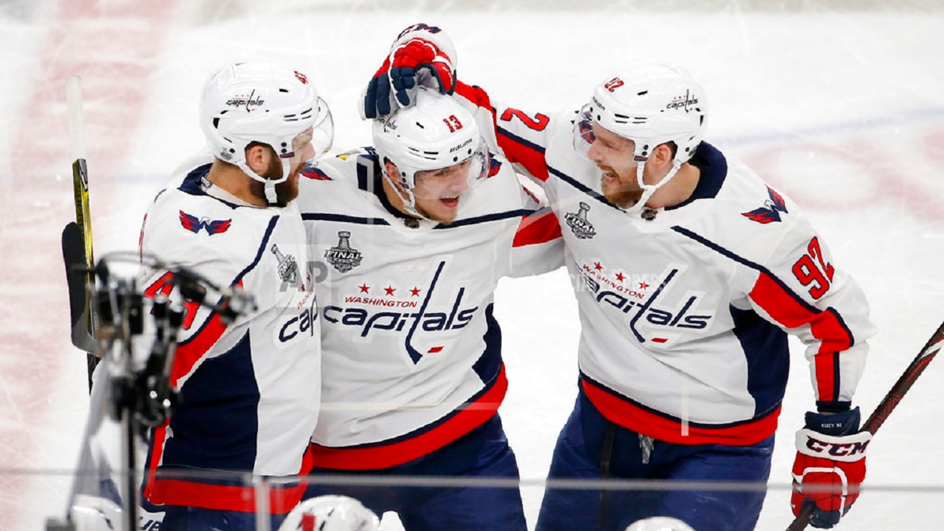 Washington Capitals left wing Jakub Vrana, center, celebrates his goal with right wing Tom Wilson, left, and center Evgeny Kuznetsov during the second period in Game 5 of the NHL hockey Stanley Cup Final against the Vegas Golden Knights, in Las Vegas, June 7, 2018.