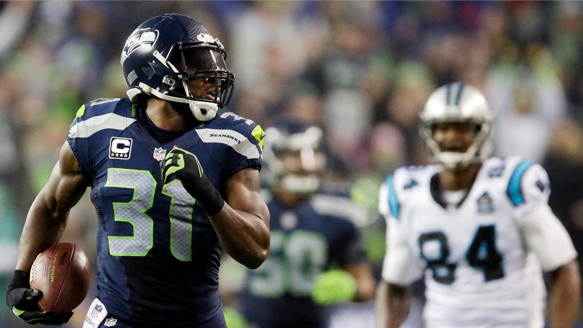 Jan. 10, 2015: Seattle Seahawks strong safety Kam Chancellor (31) runs in front of Carolina Panthers tight end Ed Dickson (84) to score on an interception 90 yards for a touchdown during the second half of an NFL divisional playoff football game in Seattle
