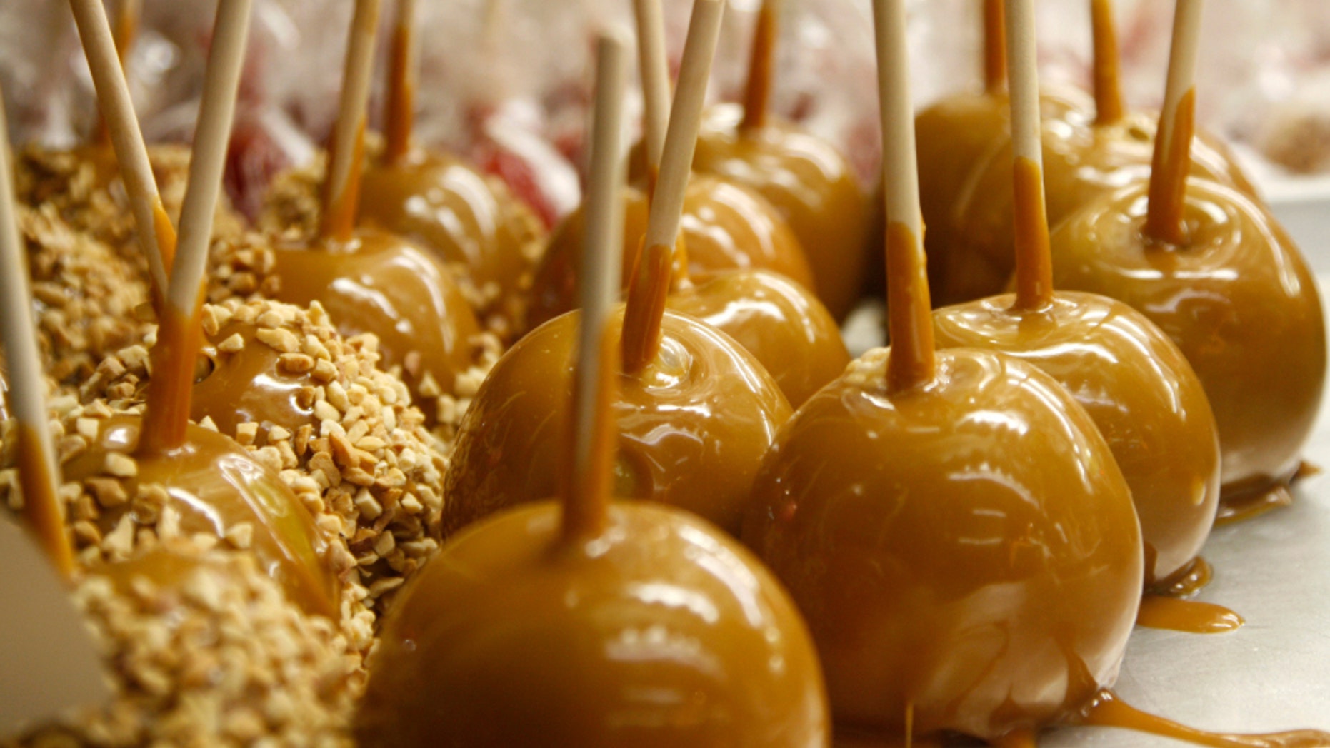 Freshly made caramel apples on a tray.