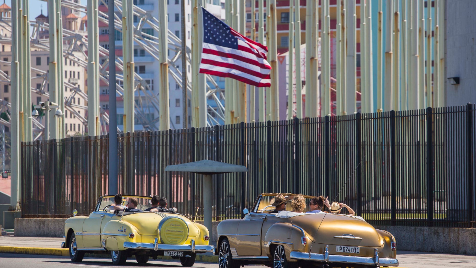 American convertibles pass by the United States embassy in Havana, Cuba, on Feb. 18, 2016.