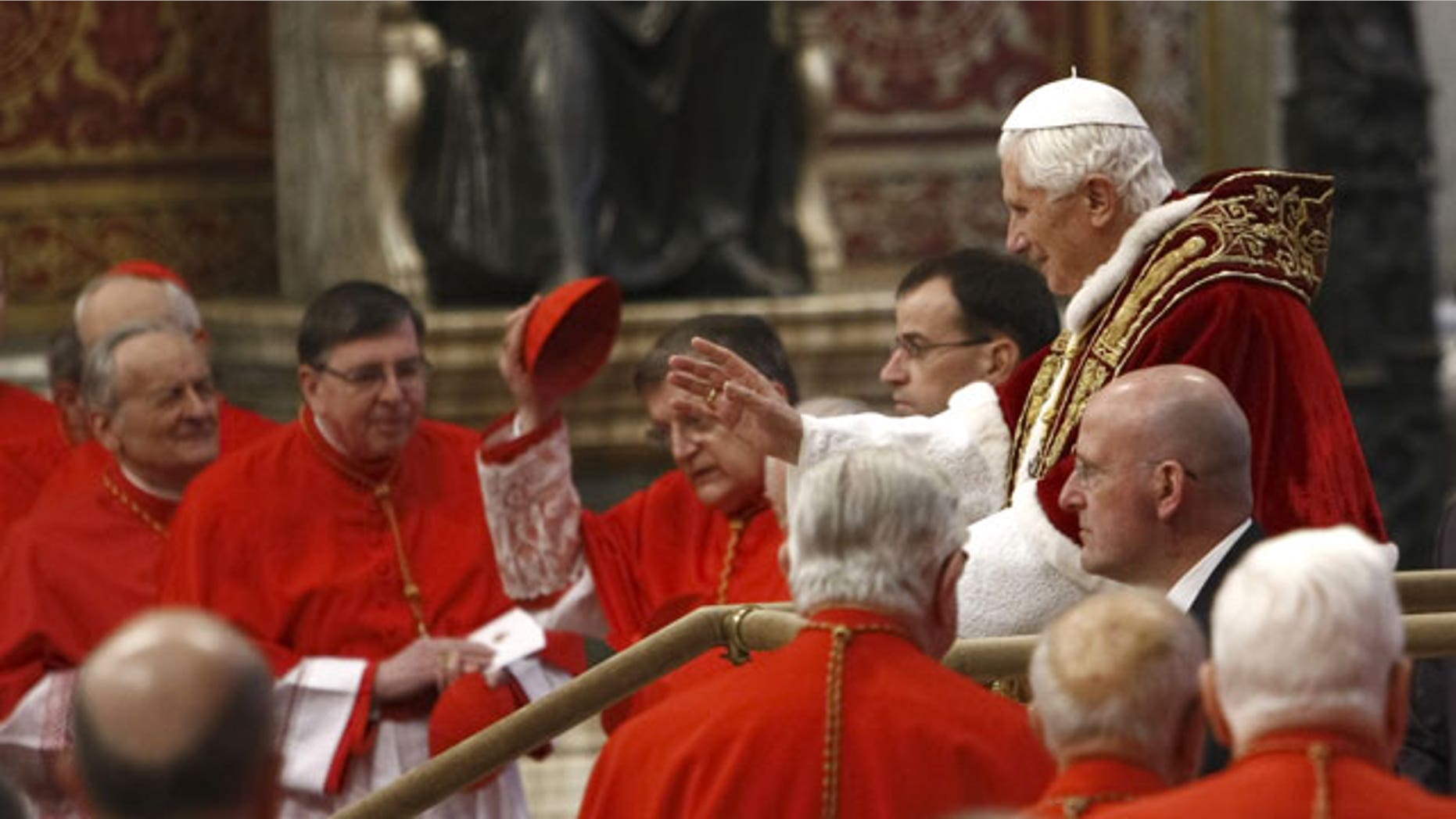 Feb. 18, 2012: Pope Benedict XVI, right, makes his way through cardinals as he arrives inside St. Peter's Basilica at the Vatican to preside over a consistory. Pope Benedict XVI is bringing 22 new Catholic churchmen into the elite club of cardinals who will elect his successor amid signs the 84-year-old pontiff is slowing down.