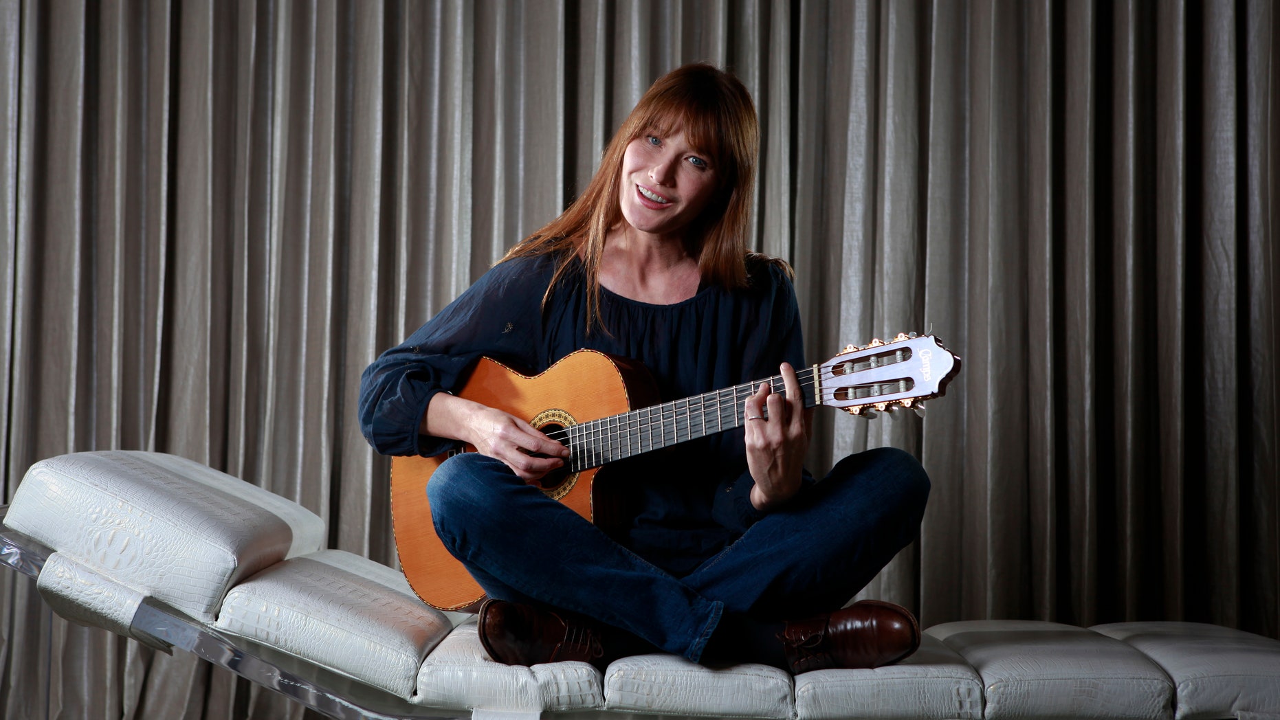 June 25, 2013. Singer Carla Bruni-Sarkozy sings as she poses for a portrait to promote her new album "Little French Songs" in New York.