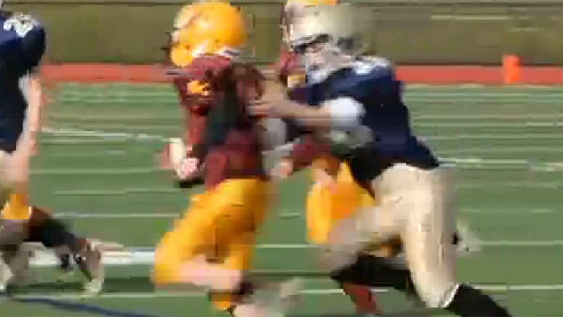 This undated screen shot shows Caroline Pla, right, making a tackle during a football game.