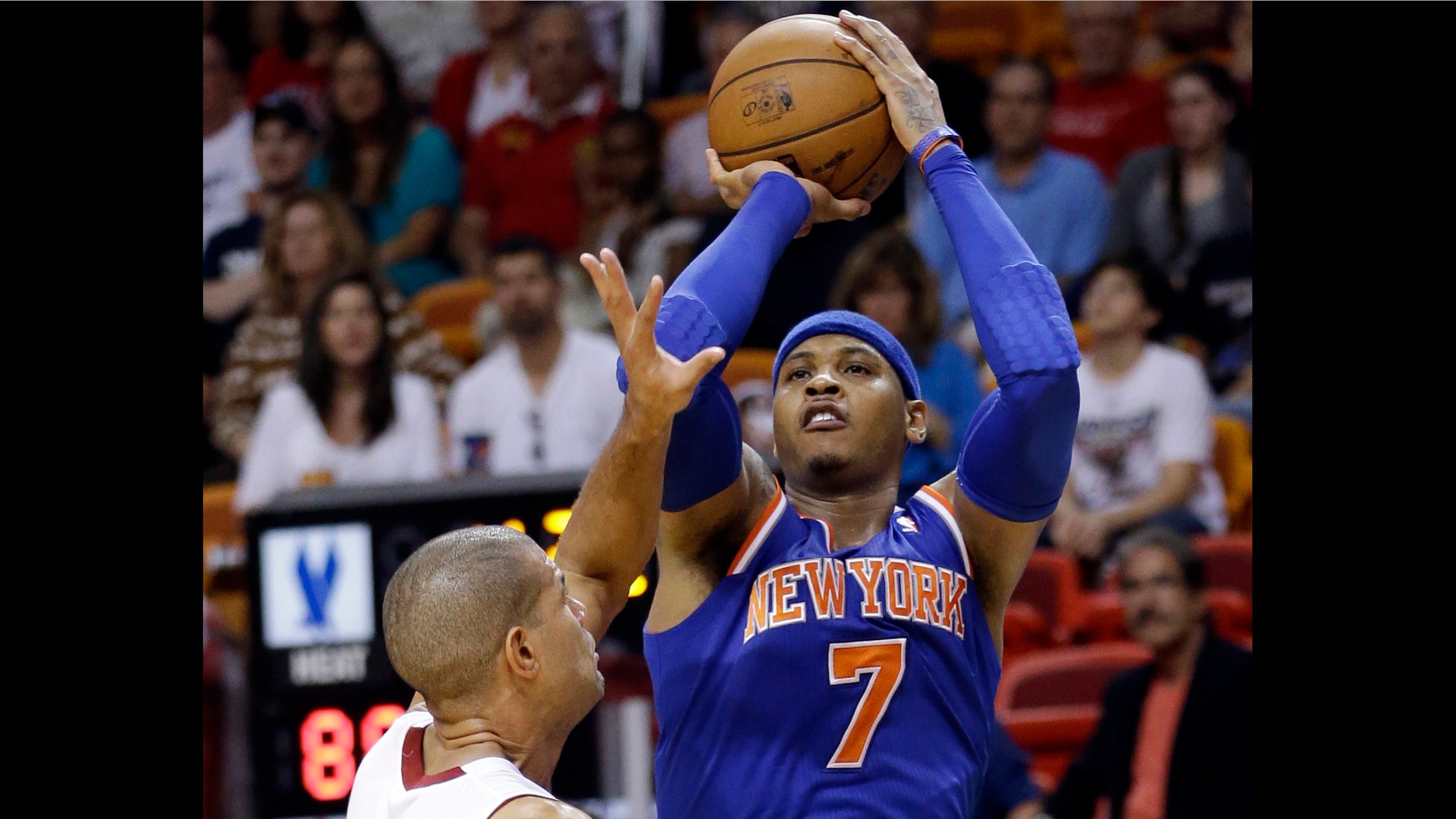 New York Knicks forward Carmelo Anthony (7) takes a shot against Miami Heat forward Shane Battier during the second half of an NBA basketball game, Tuesday, April 2, 2013 in Miami. Anthony tied his career high with 50 points in the Knicks' 102-90 win. (AP Photo/Wilfredo Lee)