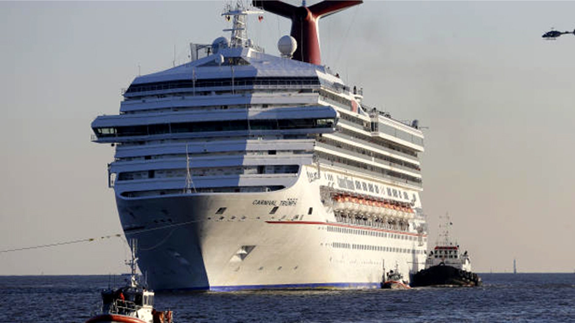 Feb. 14, 2013: The Carnival Triumph being towed into Mobile Bay, Ala., after it was disabled in the Gulf of Mexico following an engine room fire.