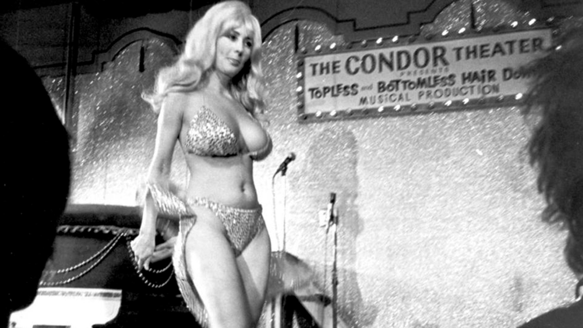 File - In this Sept. 21, 1978 file photo, Carol Doda performs at the Condor Theater in San Francisco. Doda, the legendary stripper who jiggled in America's first topless bar more than 50 years ago, has died in San Francisco of complications related to kidney failure, friends confirmed. She died Monday, Nov. 9, 2015 at age 78. (AP Photo/File)